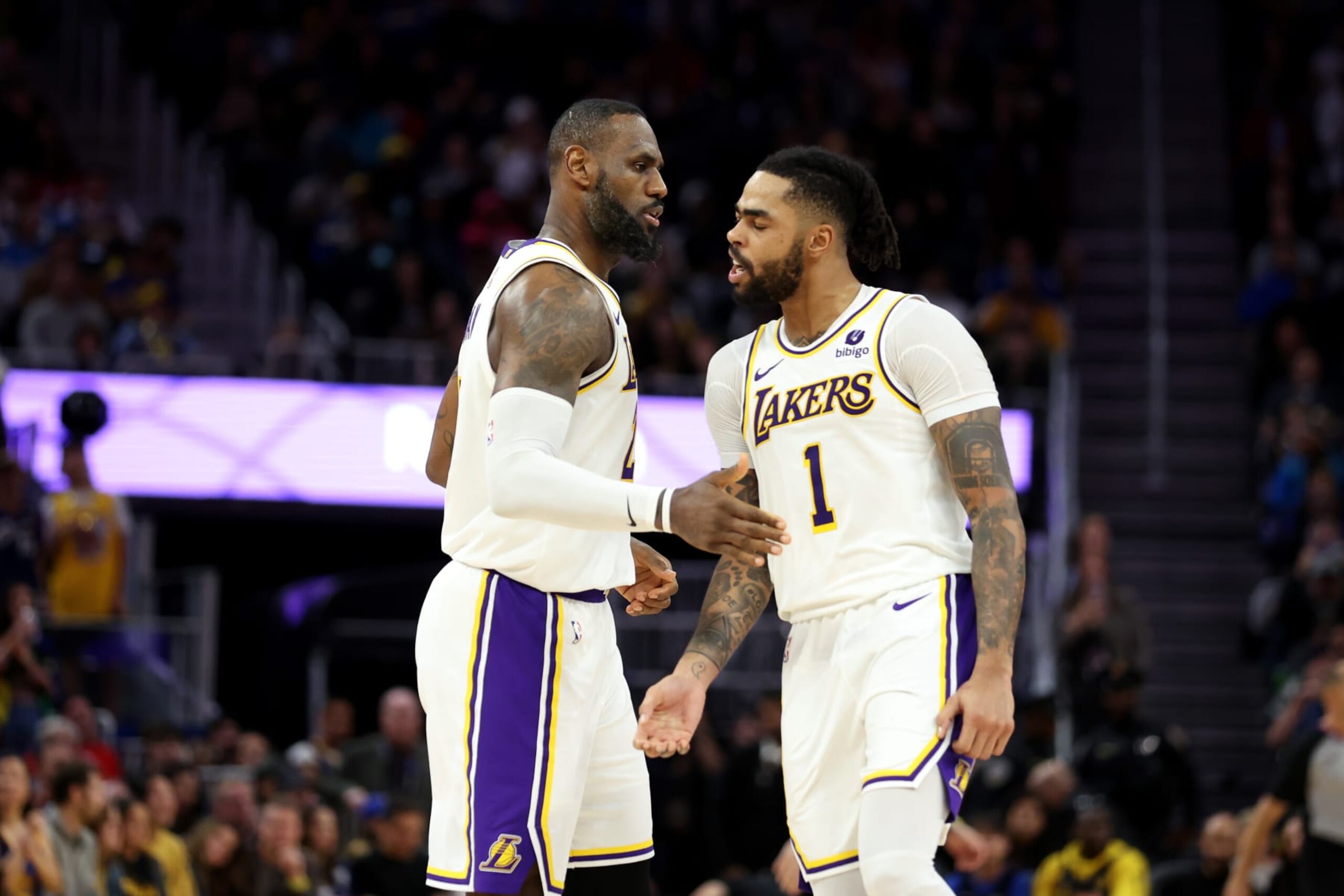 SAN FRANCISCO, CALIFORNIA - JANUARY 27: LeBron James #23 of the Los Angeles Lakers is congratulated by D'Angelo Russell #1 after he made a basket in double overtime against the Golden State Warriors at Chase Center on January 27, 2024 in San Francisco, California. The Lakers won 145-144. NOTE TO USER: User expressly acknowledges and agrees that, by downloading and or using this photograph, User is consenting to the terms and conditions of the Getty Images License Agreement.  (Photo by Ezra Shaw/Getty Images)