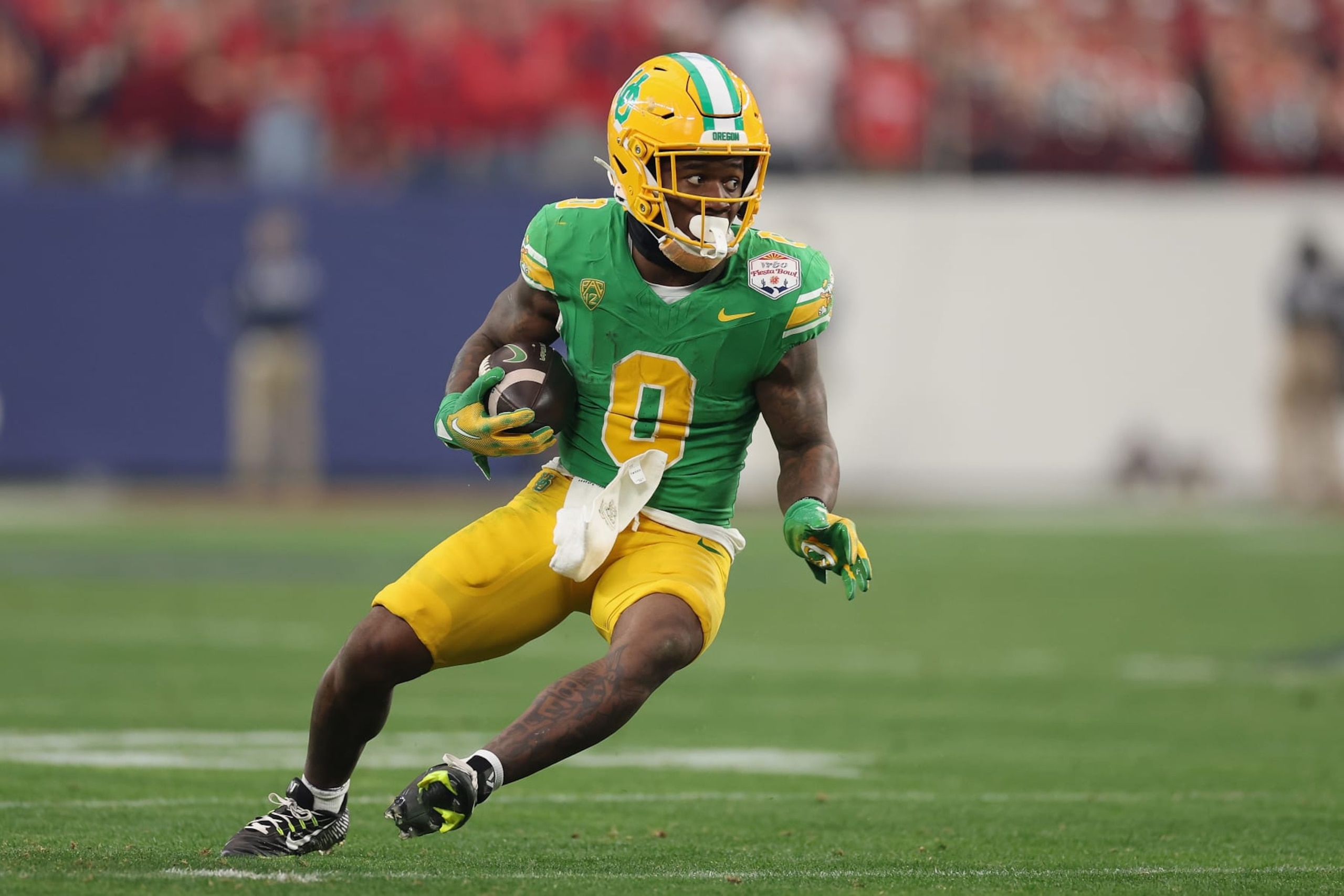 GLENDALE, ARIZONA - JANUARY 01: Running back Bucky Irving #0 of the Oregon Ducks rushes the football during the second half of the Fiesta Bowl at State Farm Stadium on January 01, 2024 in Glendale, Arizona. The Ducks defeated the Flames 45-6. (Photo by Christian Petersen/Getty Images) GLENDALE, ARIZONA - JANUARY 01: Running back Bucky Irving #0 of the Oregon Ducks rushes the football during the second half of the Fiesta Bowl at State Farm Stadium on January 01, 2024 in Glendale, Arizona. The Ducks defeated the Flames 45-6. (Photo by Christian Petersen/Getty Images)