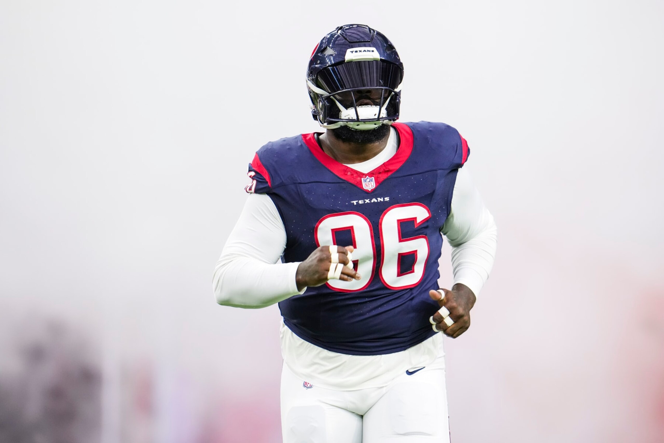 HOUSTON, TX - DECEMBER 24: Maliek Collins #96 of the Houston Texans runs out of the tunnel prior to an NFL football game against the Cleveland Browns at NRG Stadium on December 24, 2023 in Houston, Texas. (Photo by Cooper Neill/Getty Images)