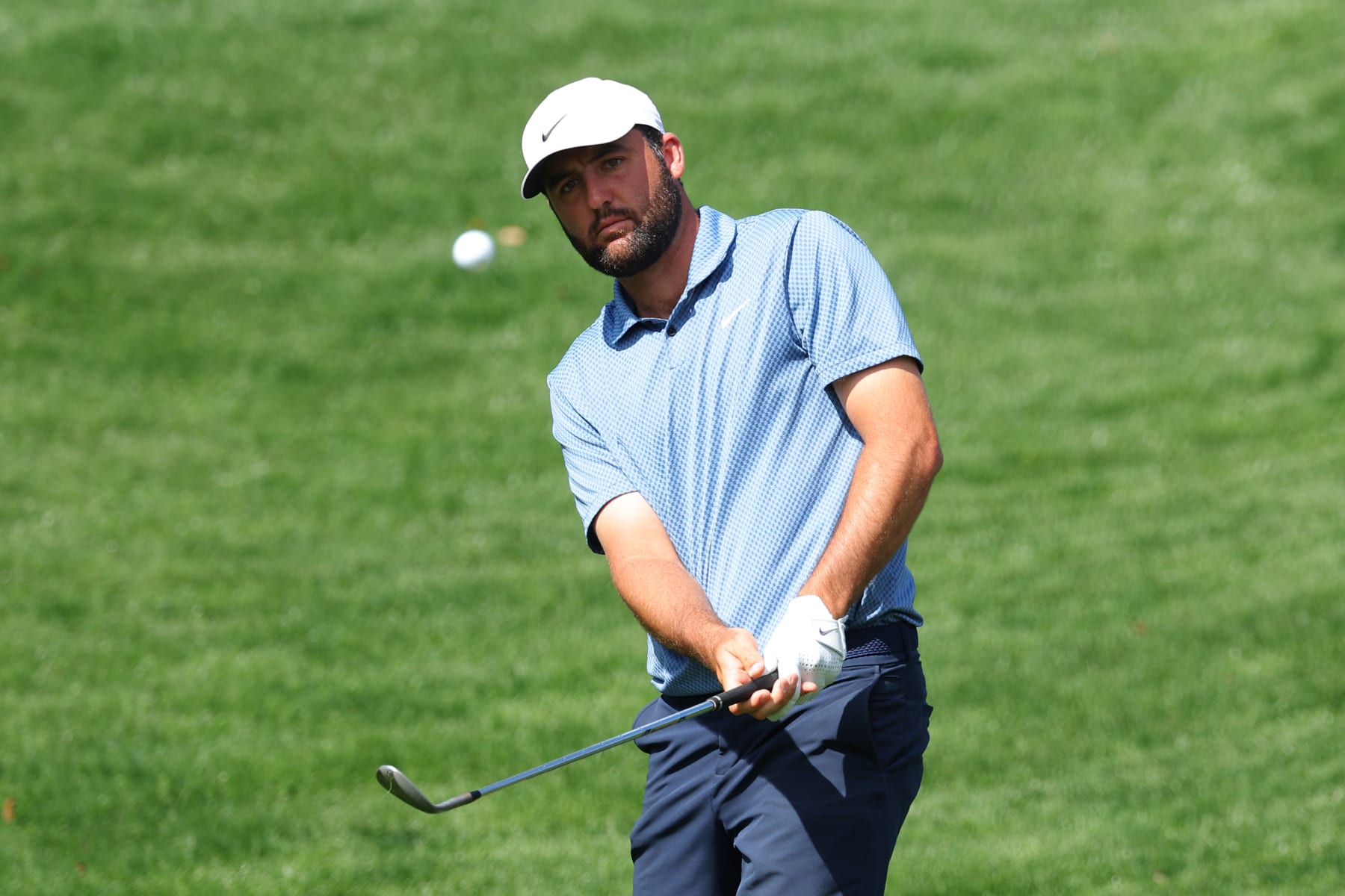PONTE VEDRA BEACH, FLORIDA - MARCH 13: Scottie Scheffler of the United States chips onto the fifth green during a practice round prior to THE PLAYERS Championship  on the Stadium Course at TPC Sawgrass on March 13, 2024 in Ponte Vedra Beach, Florida. (Photo by Kevin C. Cox/Getty Images)