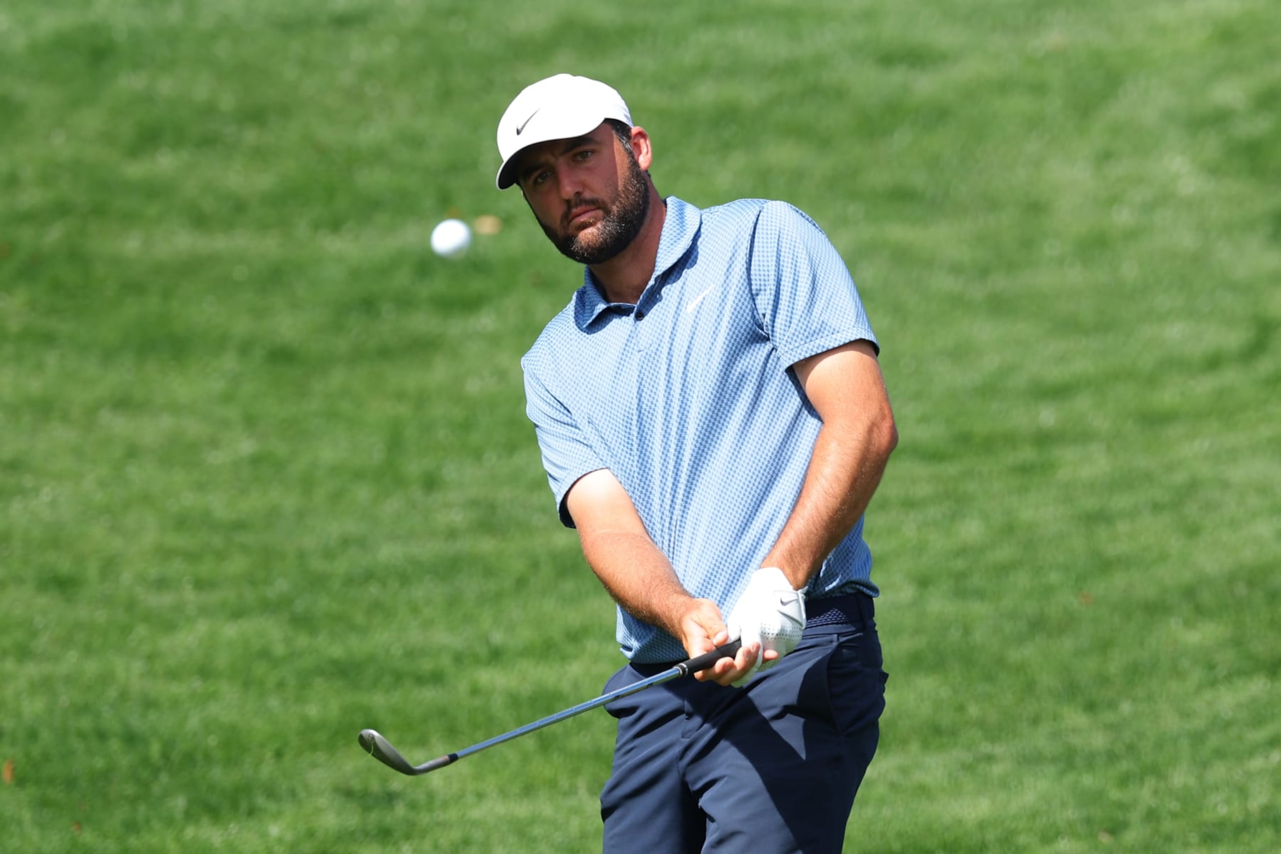 PONTE VEDRA BEACH, FLORIDA - MARCH 13: Scottie Scheffler of the United States chips onto the fifth green during a practice round prior to THE PLAYERS Championship  on the Stadium Course at TPC Sawgrass on March 13, 2024 in Ponte Vedra Beach, Florida. (Photo by Kevin C. Cox/Getty Images)