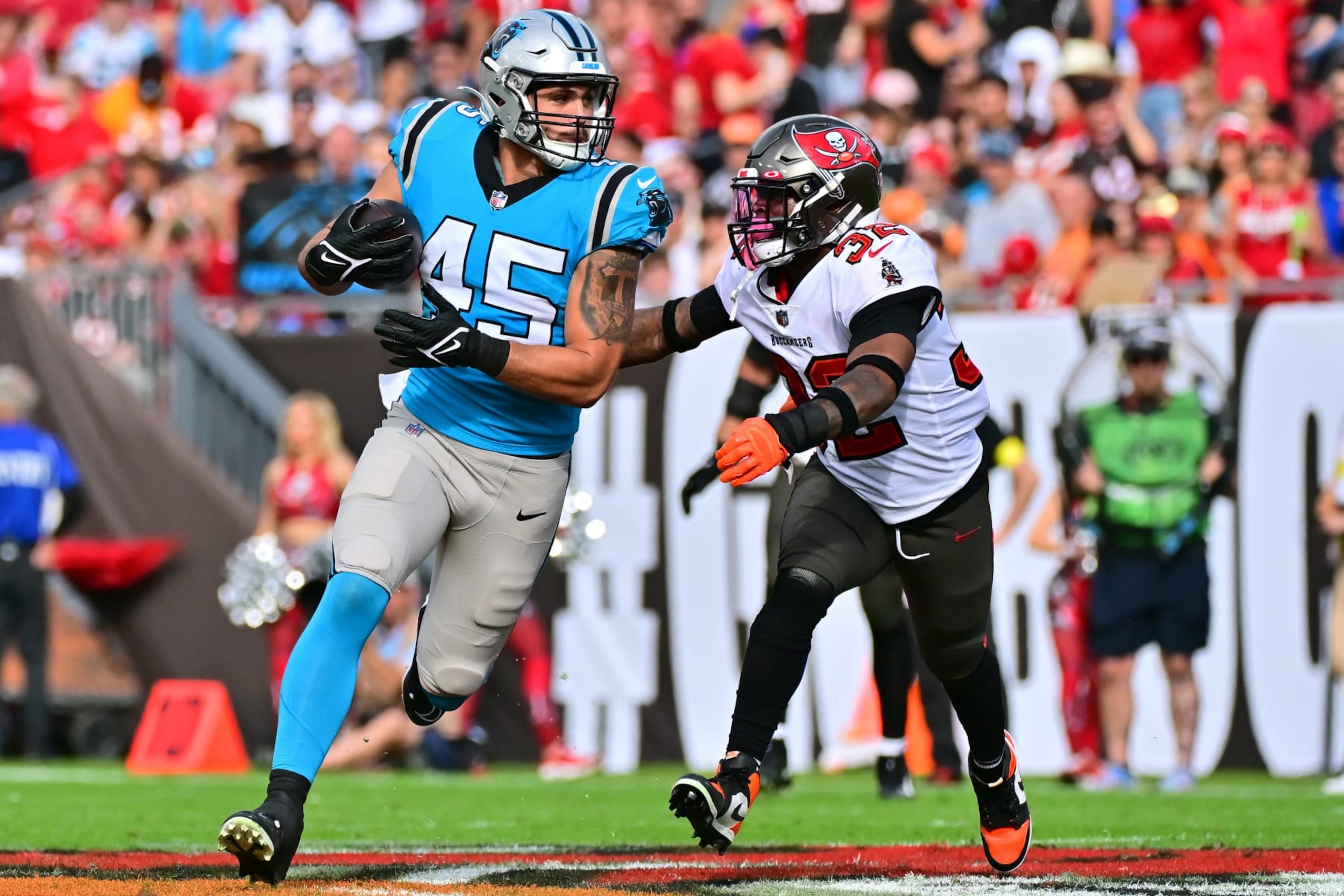 TAMPA, FLORIDA - JANUARY 01: Giovanni Ricci #45 of the Carolina Panthers runs the ball against Mike Edwards #32 of the Tampa Bay Buccaneers during the third quarter at Raymond James Stadium on January 01, 2023 in Tampa, Florida. (Photo by Julio Aguilar/Getty Images)