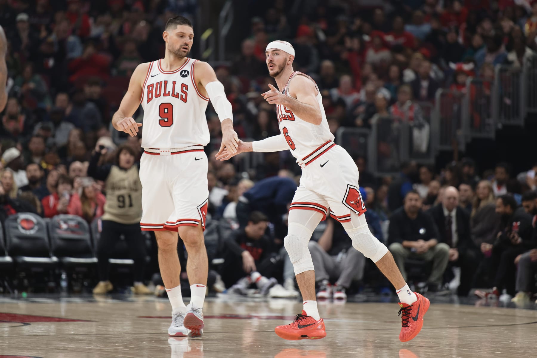 CHICAGO, ILLINOIS - JANUARY 20:  Alex Caruso #6 of the Chicago Bulls celebrates with Nikola Vucevic against the Memphis Grizzlies on January 20, 2024 at United Center in Chicago, Illinois.   NOTE TO USER: User expressly acknowledges and agrees that, by downloading and or using this photograph, User is consenting to the terms and conditions of the Getty Images License Agreement.  (Photo by Jamie Sabau/Getty Images)