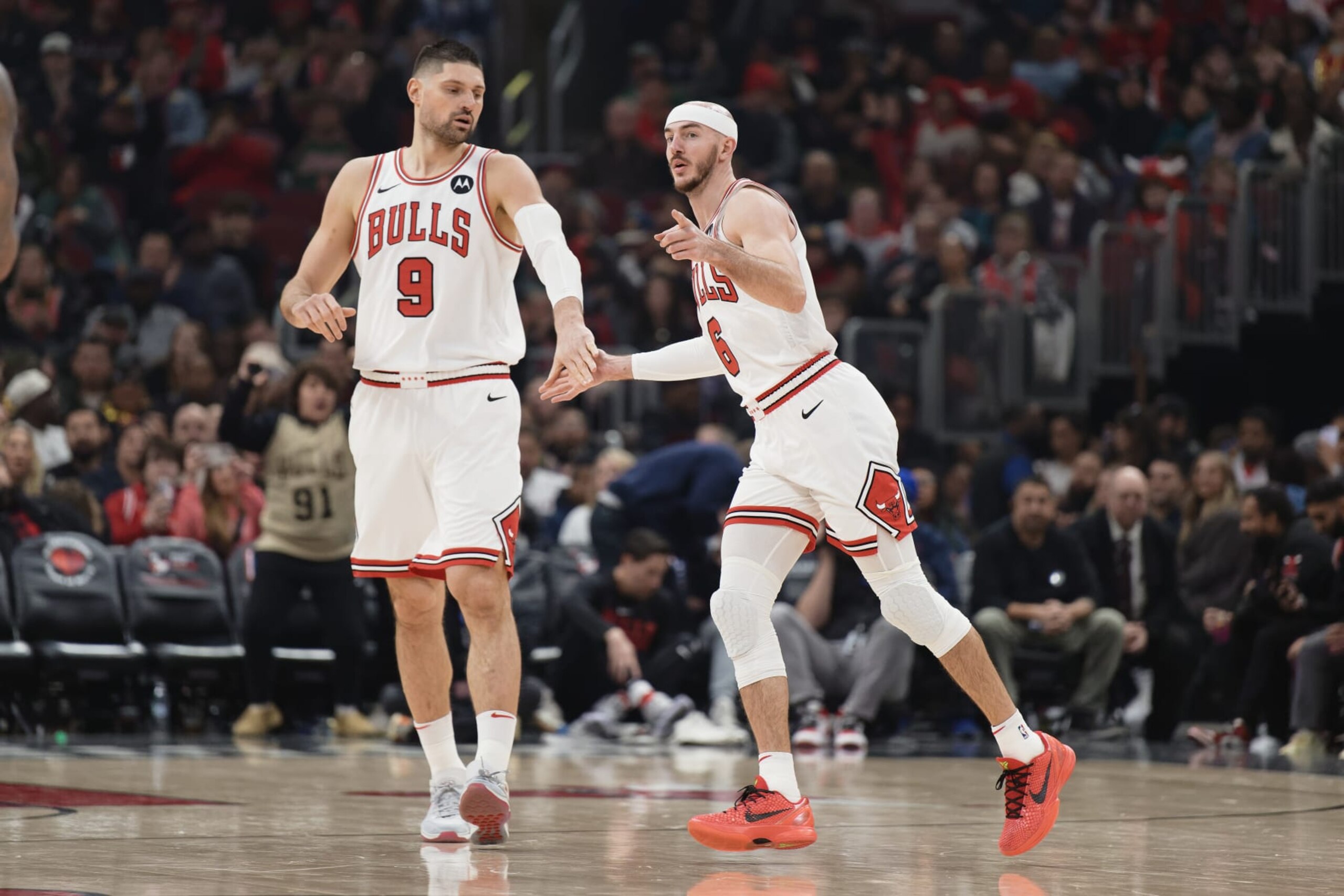 CHICAGO, ILLINOIS - JANUARY 20:  Alex Caruso #6 of the Chicago Bulls celebrates with Nikola Vucevic against the Memphis Grizzlies on January 20, 2024 at United Center in Chicago, Illinois.   NOTE TO USER: User expressly acknowledges and agrees that, by downloading and or using this photograph, User is consenting to the terms and conditions of the Getty Images License Agreement.  (Photo by Jamie Sabau/Getty Images)