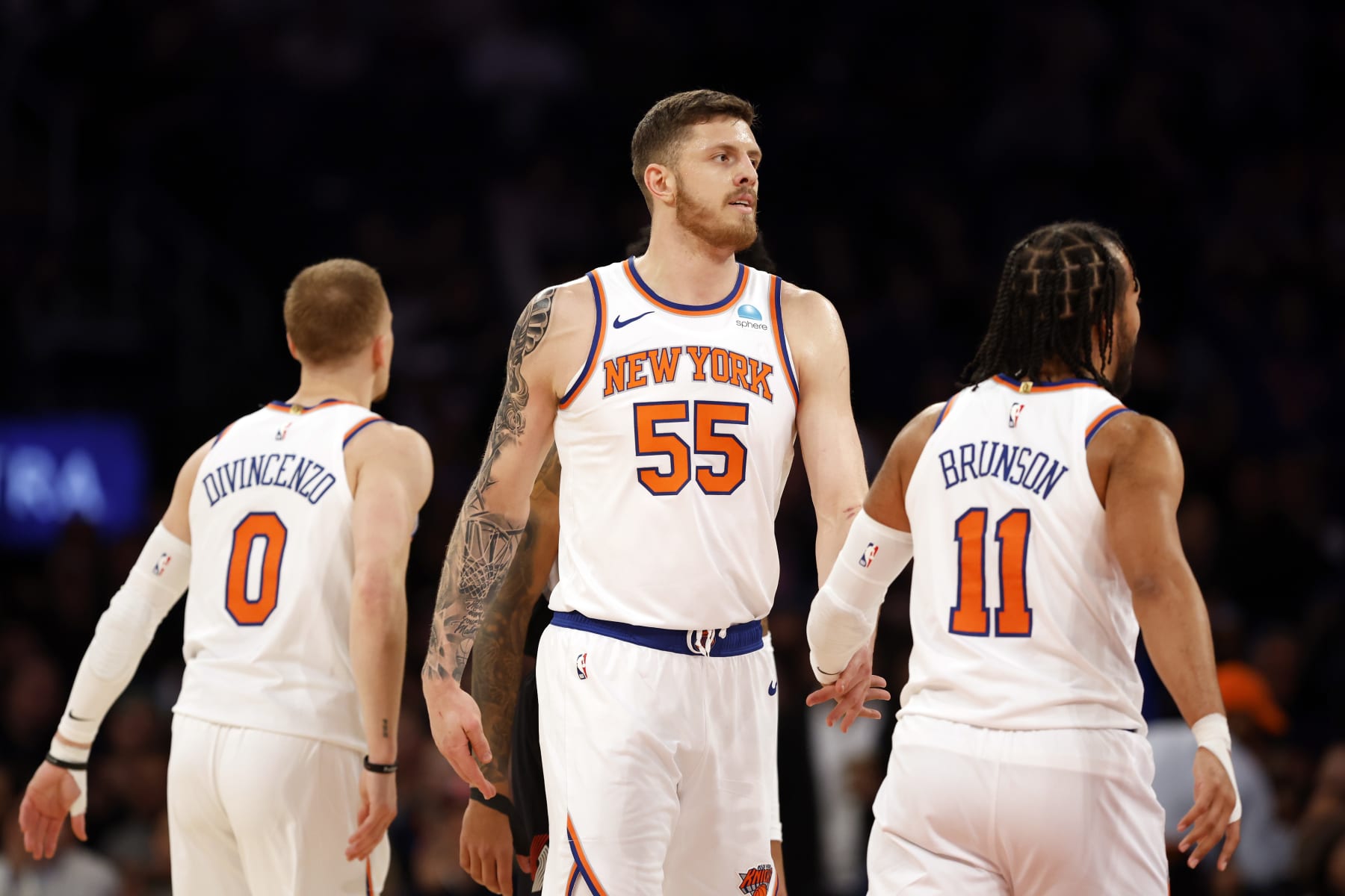 NEW YORK, NEW YORK - JANUARY 09: Isaiah Hartenstein #55 reacts with Donte DiVincenzo #0 and Jalen Brunson #11 of the New York Knicks during the first half against the Portland Trail Blazers at Madison Square Garden on January 09, 2024 in New York City. NOTE TO USER: User expressly acknowledges and agrees that, by downloading and/or using this Photograph, user is consenting to the terms and conditions of the Getty Images License Agreement. (Photo by Sarah Stier/Getty Images)