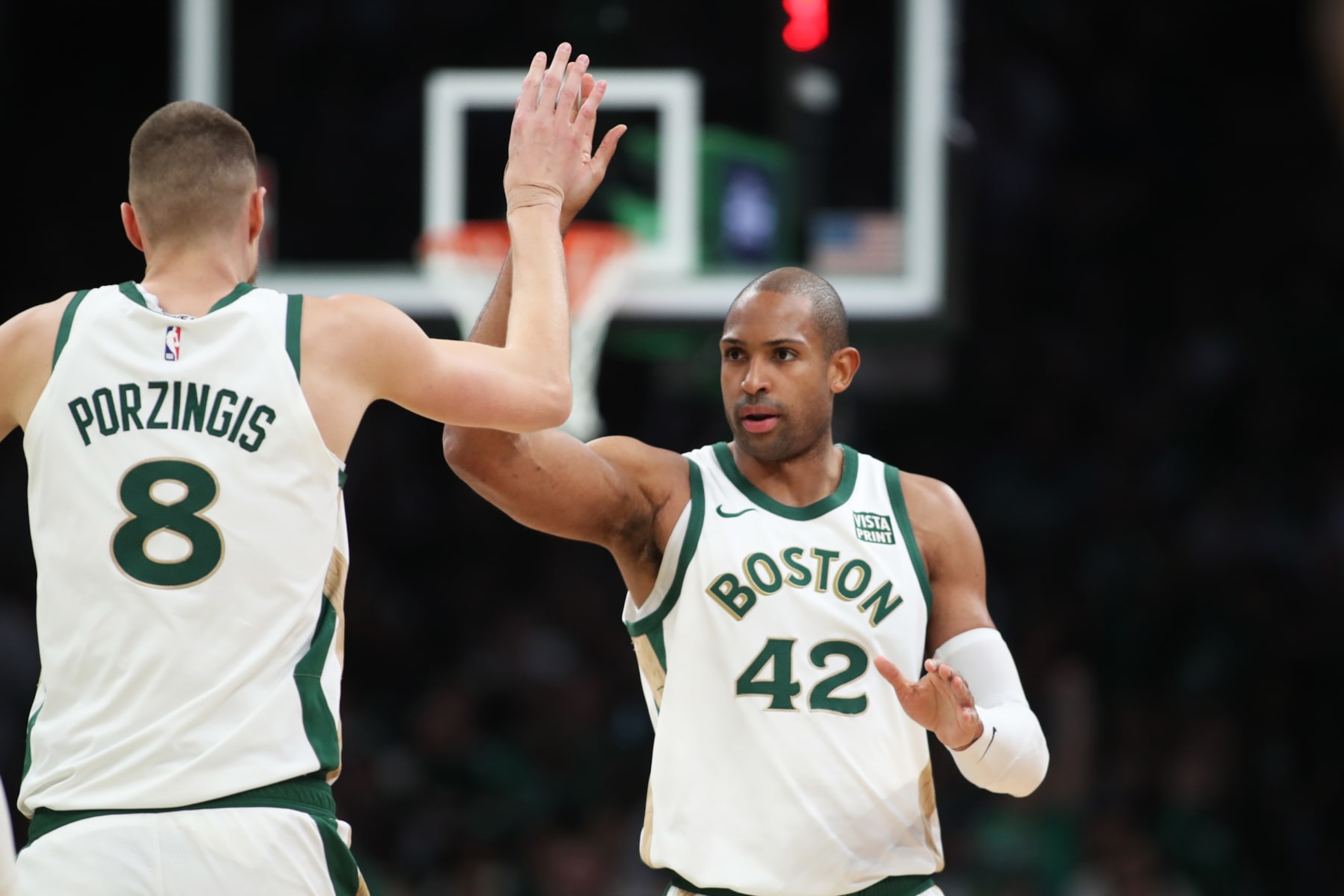 BOSTON, MASSACHUSETTS - FEBRUARY 04: Al Horford #42 and Kristaps Porzingis #8 of the Boston Celtics celebrate after a basket at TD Garden on February 04, 2024 in Boston, Massachusetts. NOTE TO USER: User expressly acknowledges and agrees that, by downloading and or using this photograph, User is consenting to the terms and conditions of the Getty Images License Agreement. (Photo by Paul Rutherford/Getty Images)