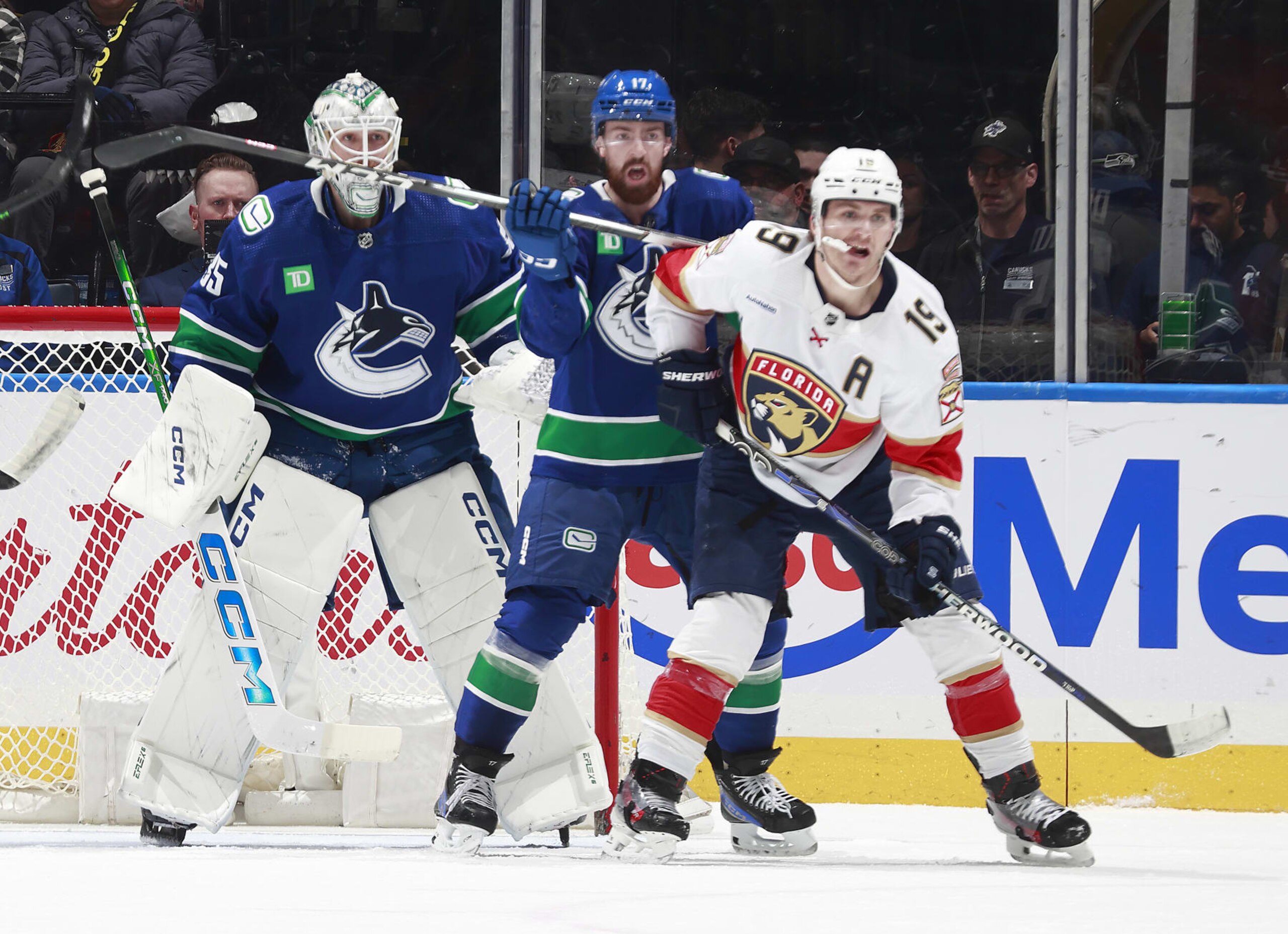 VANCOUVER, CANADA - DECEMBER 14: Filip Hronek #17 of the Vancouver Canucks checks Matthew Tkachuk #19 of the Florida Panthers during their NHL game at Rogers Arena on December 14, 2023 in Vancouver, British Columbia, Canada.  (Photo by Jeff Vinnick/NHLI via Getty Images)