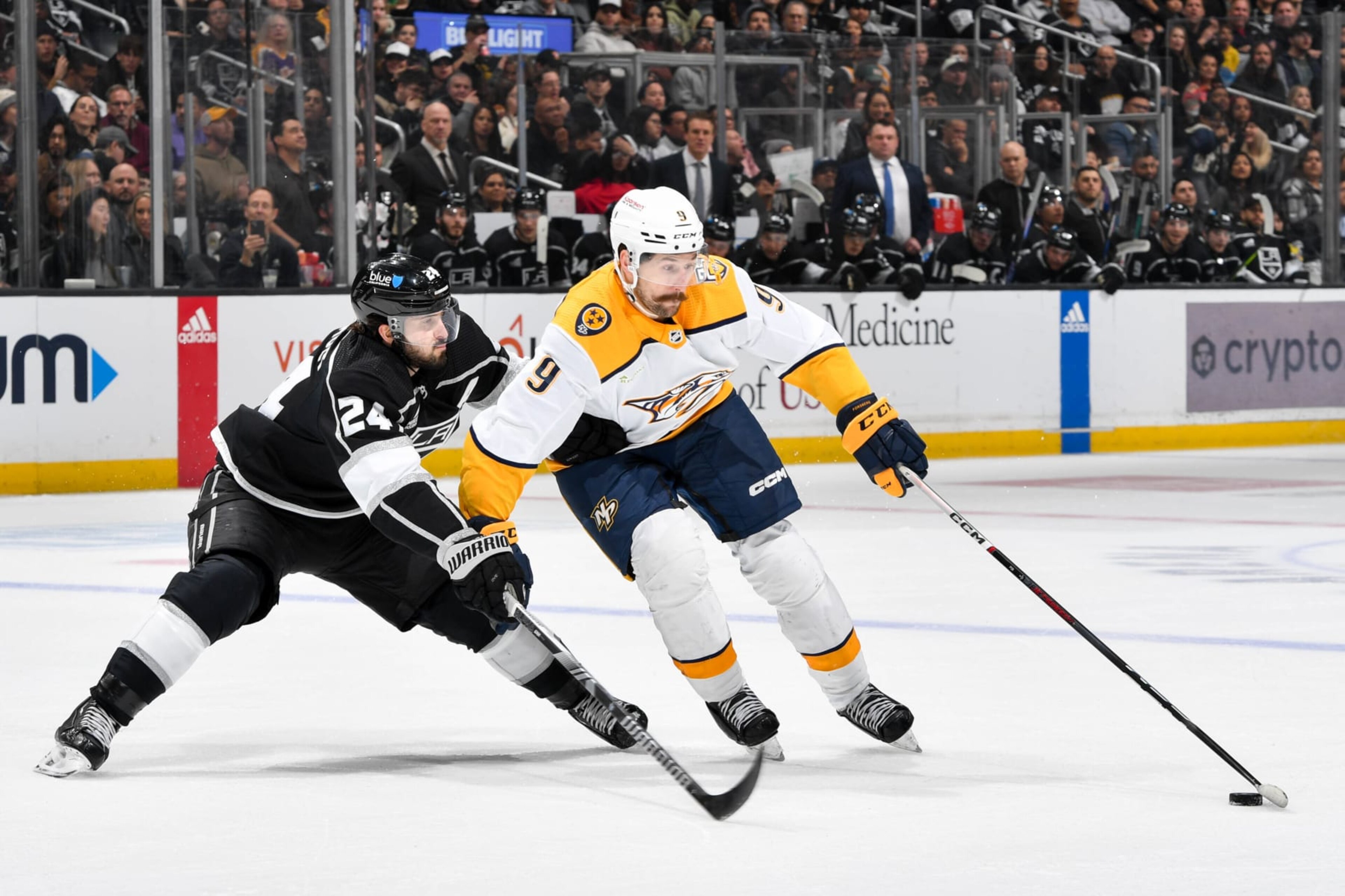 LOS ANGELES, CA - FEBRUARY 22: Phillip Danault #24 of the Los Angeles Kings and Filip Forsberg #9 of the Nashville Predators battle for the puck during the second period at Crypto.com Arena on February 22, 2024 in Los Angeles, California. (Photo by Juan Ocampo/NHLI via Getty Images)