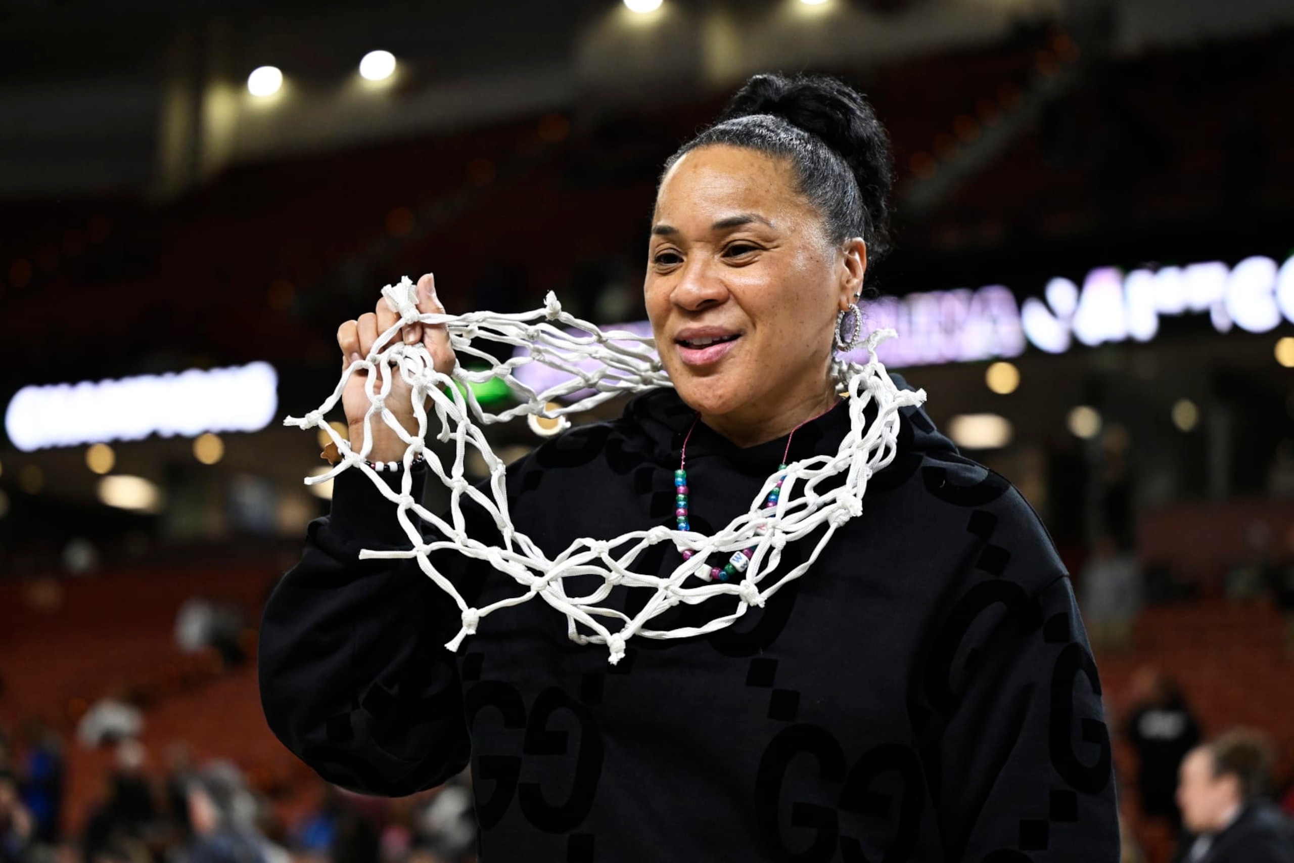 GREENVILLE, SOUTH CAROLINA - MARCH 10: Head coach Dawn Staley of the South Carolina Gamecocks wears the net after their win over the LSU Lady Tigers following the championship game of the SEC Women's Basketball Tournament at Bon Secours Wellness Arena on March 10, 2024 in Greenville, South Carolina. (Photo by Eakin Howard/Getty Images)