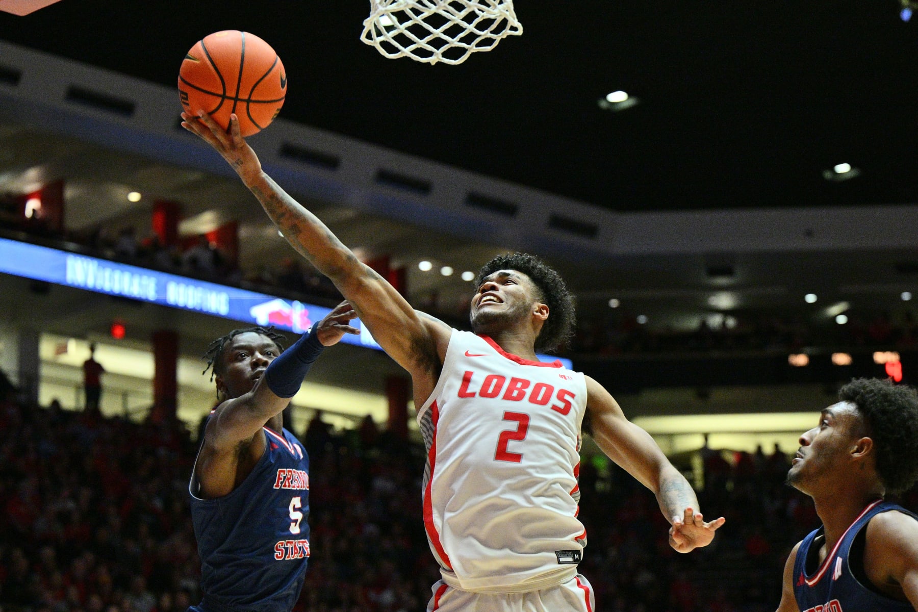 ALBUQUERQUE, NEW MEXICO - MARCH 06: Donovan Dent #2 of the New Mexico Lobos goes up for a layup against Jalen Weaver #5 of the Fresno State Bulldogs during the second half at The Pit on March 06, 2024 in Albuquerque, New Mexico. The Lobos defeated the Bulldogs 79-58. (Photo by Sam Wasson/Getty Images)
