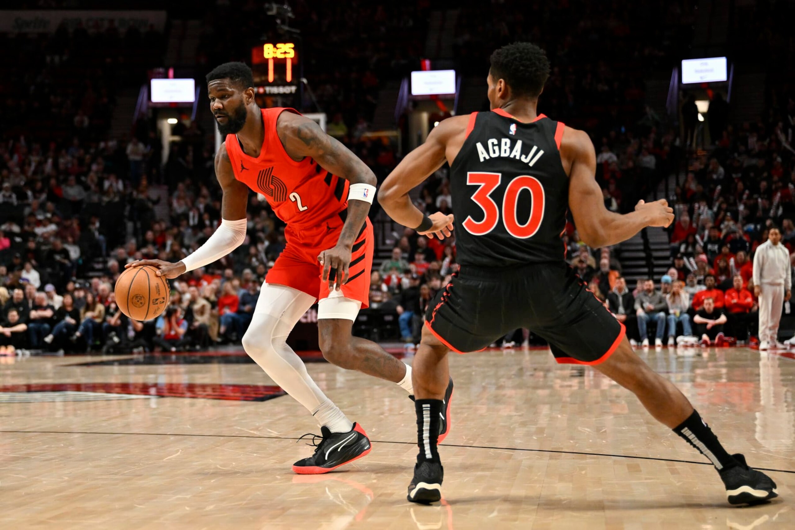 PORTLAND, OREGON - MARCH 09: Deandre Ayton #2 of the Portland Trail Blazers dribbles past Ochai Agbaji #30 of the Toronto Raptors during the first quarter of the game at the Moda Center on March 09, 2024 in Portland, Oregon. NOTE TO USER: User expressly acknowledges and agrees that, by downloading and or using this photograph, User is consenting to the terms and conditions of the Getty Images License Agreement. (Photo by Alika Jenner/Getty Images)
