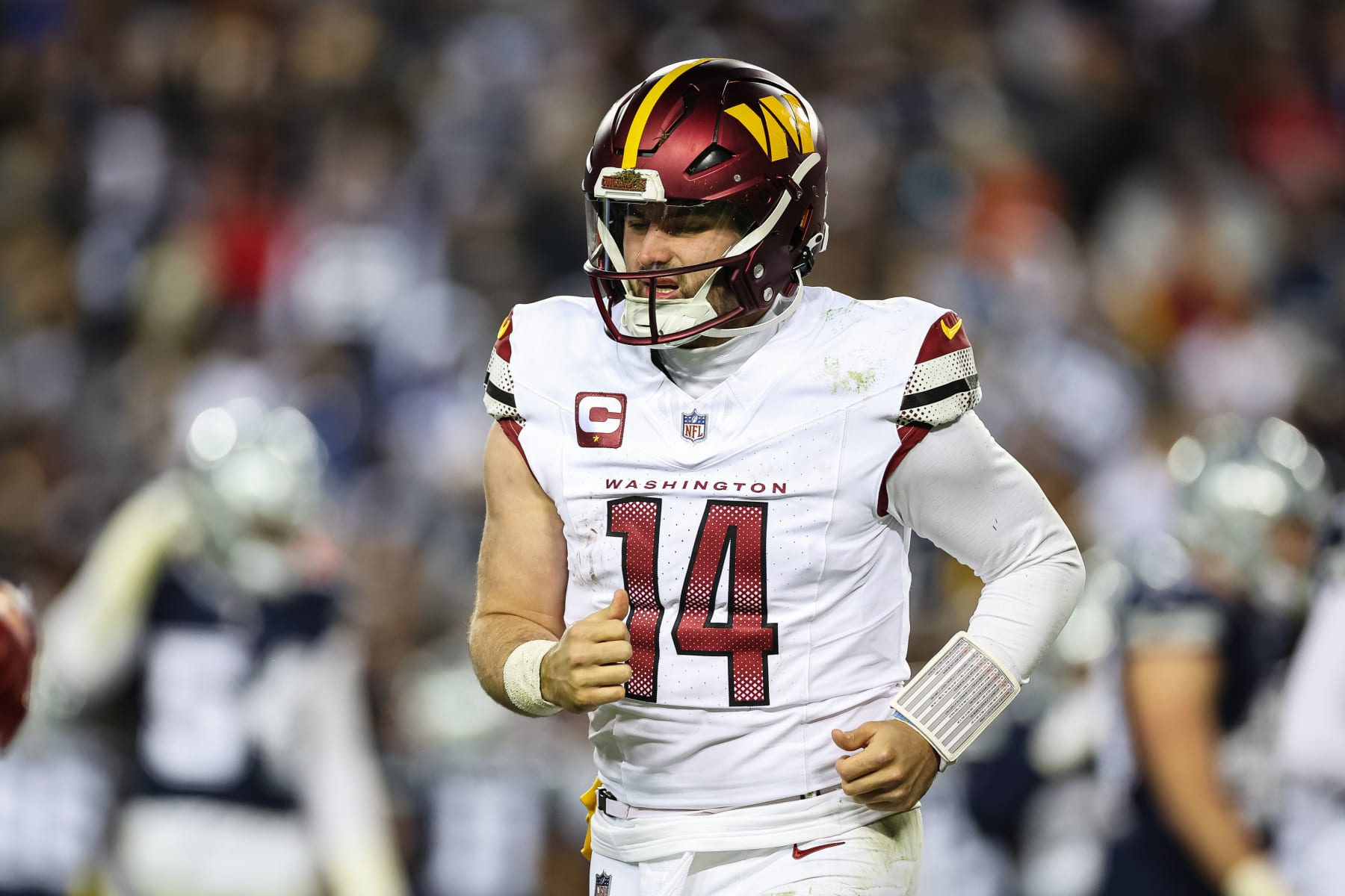 LANDOVER, MD - JANUARY 07: Sam Howell #14 of the Washington Commanders looks on after being sacked by the Dallas Cowboys during the second half of the game at FedExField on January 7, 2024 in Landover, Maryland. (Photo by Scott Taetsch/Getty Images)