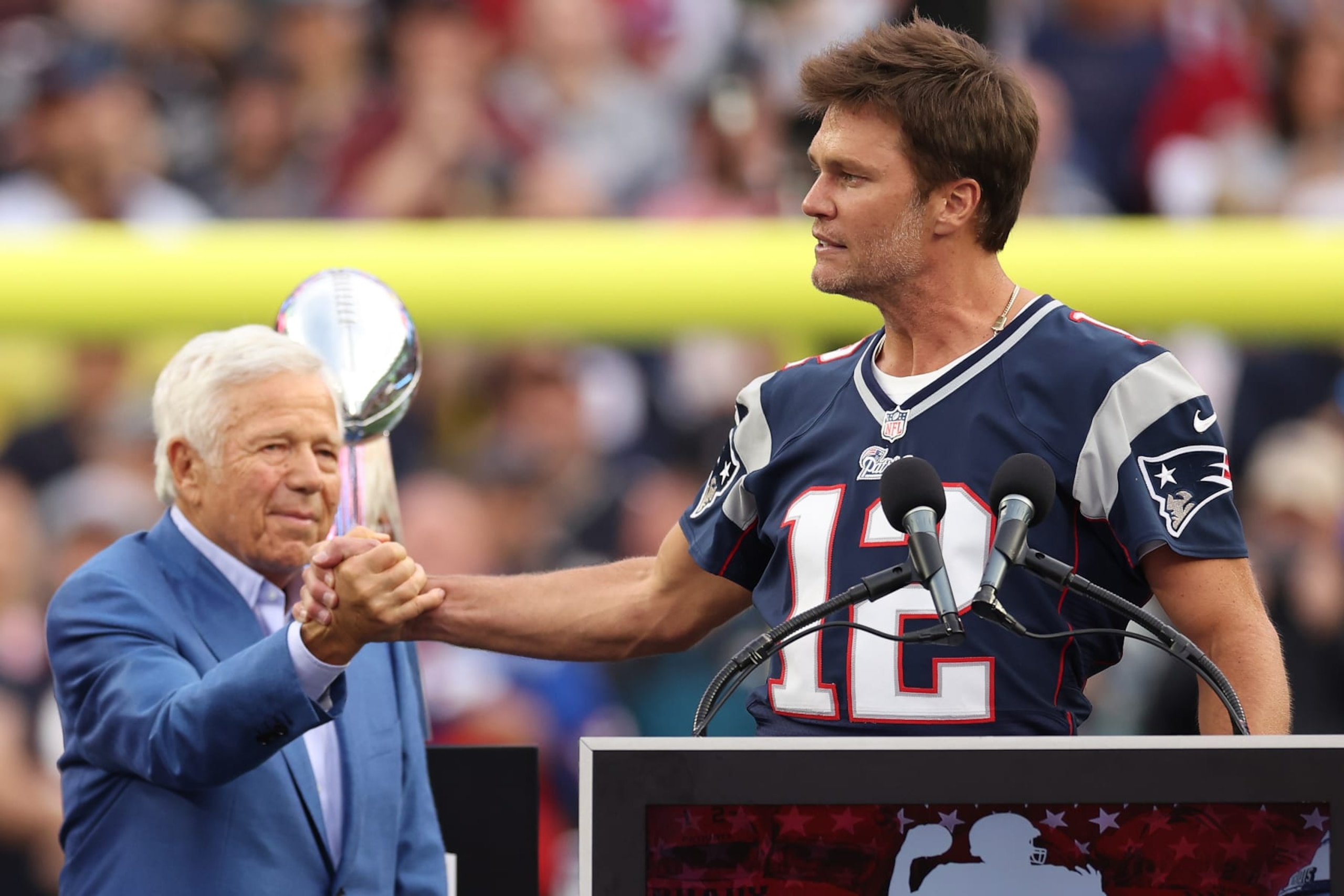 FOXBOROUGH, MASSACHUSETTS - SEPTEMBER 10: New England Patriots owner Robert Kraft shakes hands with New England Patriots quarterback Tom Brady during a ceremony honoring Brady at halftime of New England's game against the Philadelphia Eagles at Gillette Stadium on September 10, 2023 in Foxborough, Massachusetts. (Photo by Maddie Meyer/Getty Images)