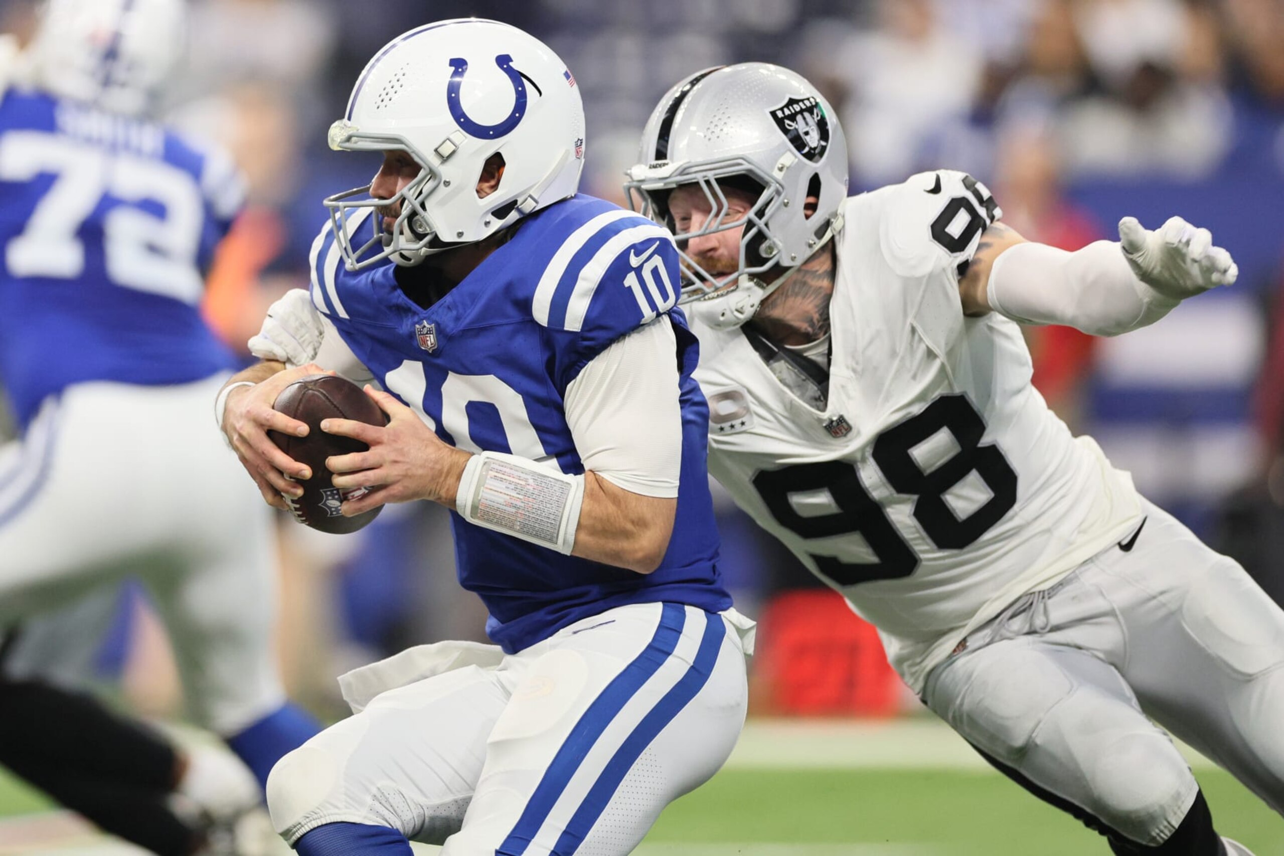 INDIANAPOLIS, INDIANA - DECEMBER 31: Maxx Crosby #98 of the Las Vegas Raiders chases Gardner Minshew #10 of the Indianapolis Colts during the first quarter at Lucas Oil Stadium on December 31, 2023 in Indianapolis, Indiana. (Photo by Andy Lyons/Getty Images)