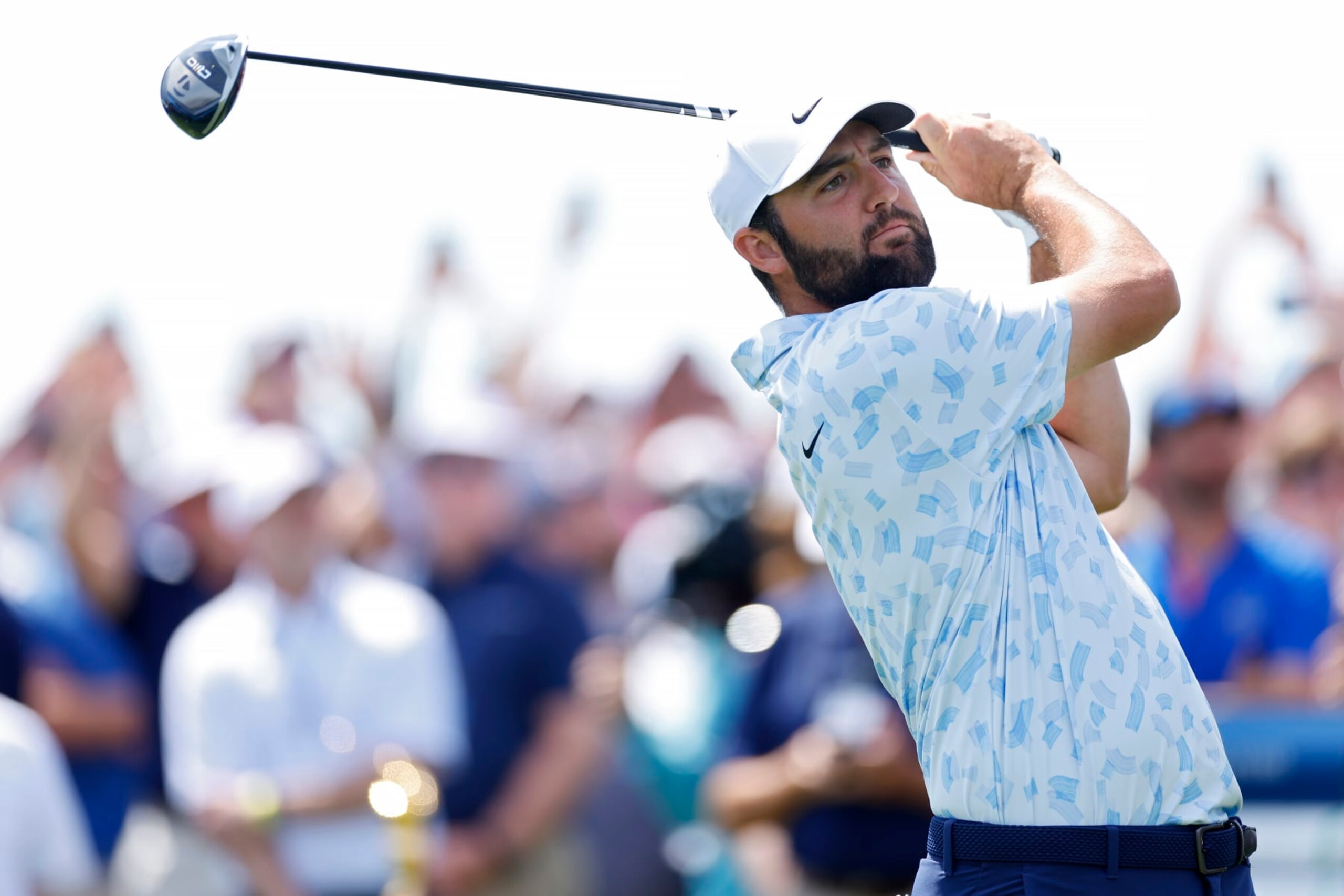 PONTE VEDRA BEACH, FLORIDA - MARCH 14: Scottie Scheffler of the United States plays his shot from the first tee during the first round of THE PLAYERS Championship on the Stadium Course at TPC Sawgrass on March 14, 2024 in Ponte Vedra Beach, Florida. (Photo by Mike Ehrmann/Getty Images)