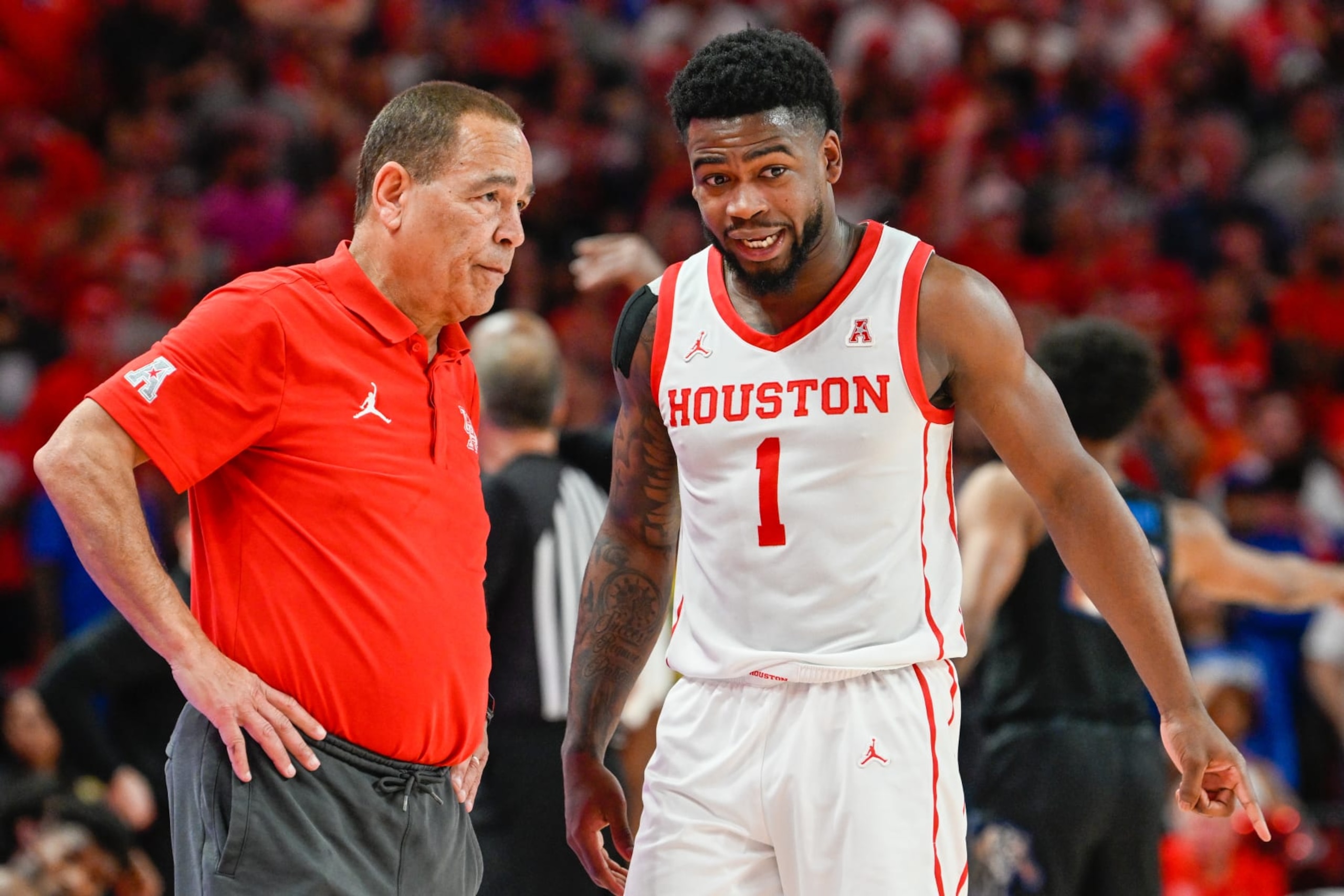 HOUSTON, TX - FEBRUARY 19: Houston Cougars head coach Kelvin Sampson coaches Houston Cougars guard Jamal Shead (1) during a stoppage of play during the basketball game between the Memphis Tigers and Houston Cougars at the Fertitta Center on February 19, 2023 in Houston, Texas. (Photo by Ken Murray/Icon Sportswire via Getty Images)