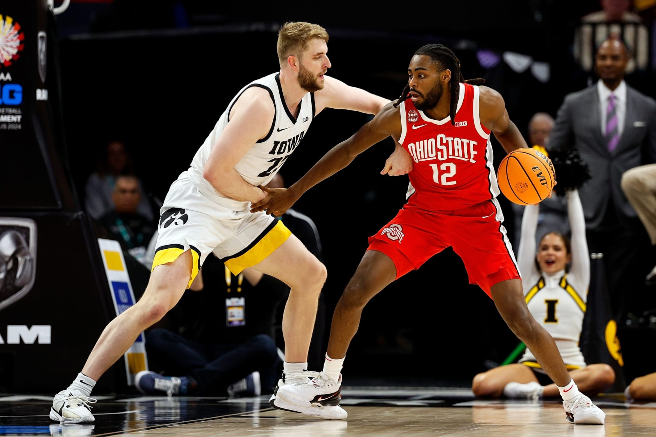 MINNEAPOLIS, MINNESOTA - MARCH 14: Evan Mahaffey #12 of the Ohio State Buckeyes dribbles the ball against Ben Krikke #23 of the Iowa Hawkeyes in the first half in the Second Round of the Big Ten Tournament at Target Center on March 14, 2024 in Minneapolis, Minnesota. (Photo by David Berding/Getty Images)