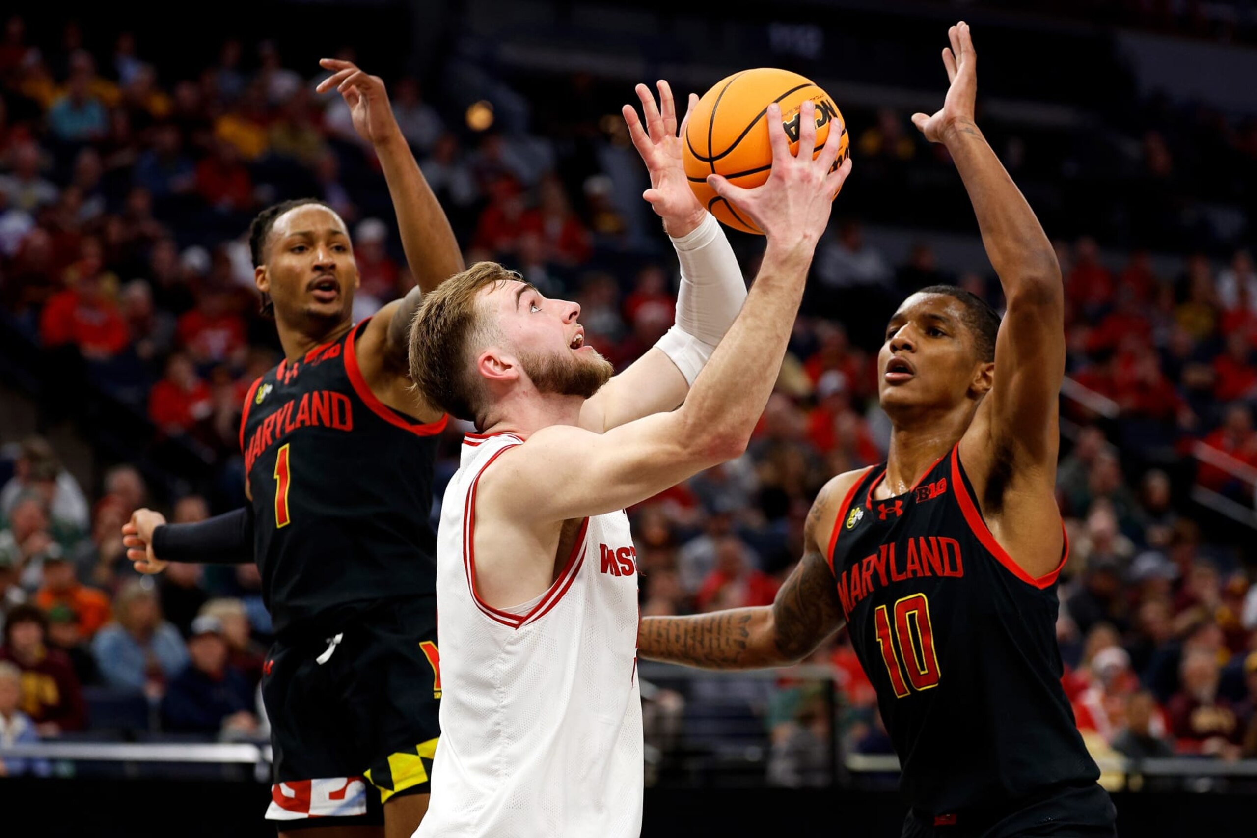MINNEAPOLIS, MINNESOTA - MARCH 14: Tyler Wahl #5 of the Wisconsin Badgers goes up for a shot against Jahmir Young #1 and Julian Reese #10 of the Maryland Terrapins in the first half in the Second Round of the Big Ten Tournament at Target Center on March 14, 2024 in Minneapolis, Minnesota. (Photo by David Berding/Getty Images)