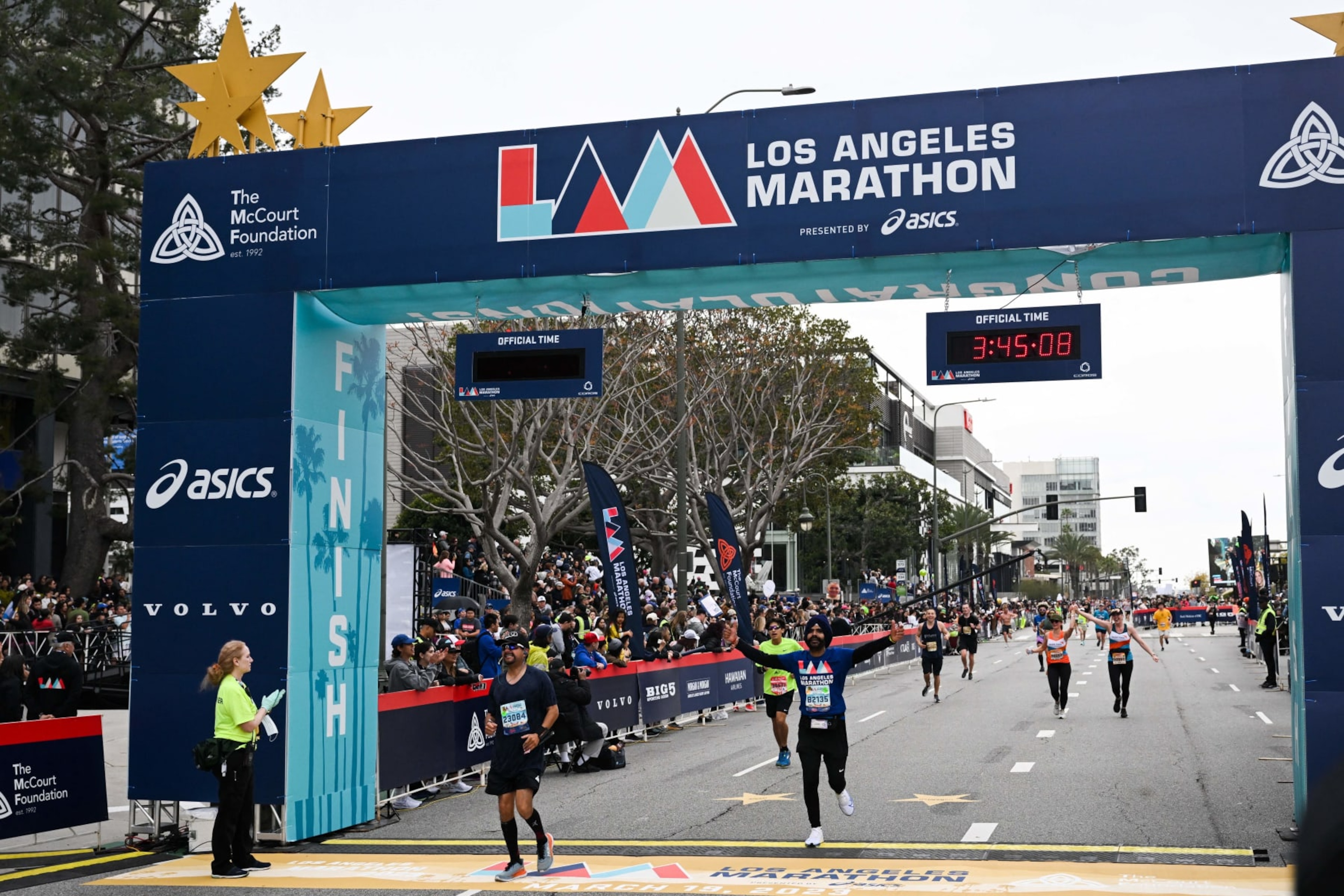 Runners cross the finish line during the 38th Los Angeles Marathon in Los Angeles, California, on March 19, 2023. (Photo by Patrick T. Fallon / AFP) (Photo by PATRICK T. FALLON/AFP via Getty Images)
