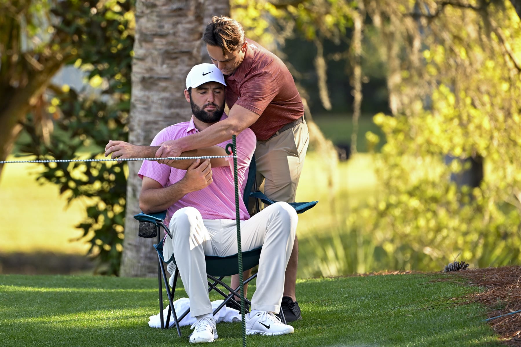 PONTE VEDRA BEACH, FLORIDA - MARCH 15: Scottie Scheffler is looked for an injury before playing the 14th hole during the second round of THE PLAYERS Championship at Stadium Course at TPC Sawgrass on March 15, 2024 in Ponte Vedra Beach, Florida. (Photo by Ben Jared/PGA TOUR via Getty Images)
