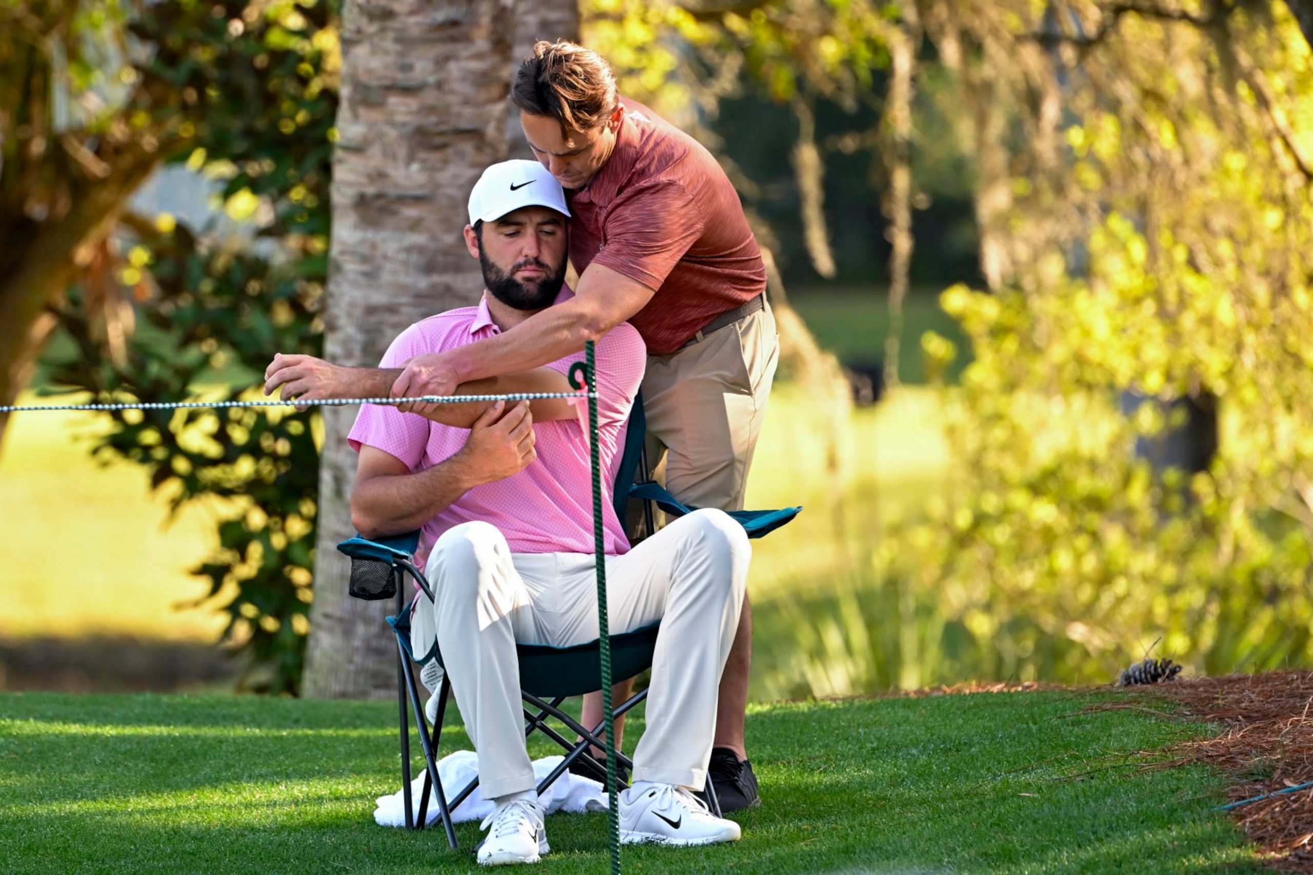 PONTE VEDRA BEACH, FLORIDA - MARCH 15: Scottie Scheffler is looked for an injury before playing the 14th hole during the second round of THE PLAYERS Championship at Stadium Course at TPC Sawgrass on March 15, 2024 in Ponte Vedra Beach, Florida. (Photo by Ben Jared/PGA TOUR via Getty Images)
