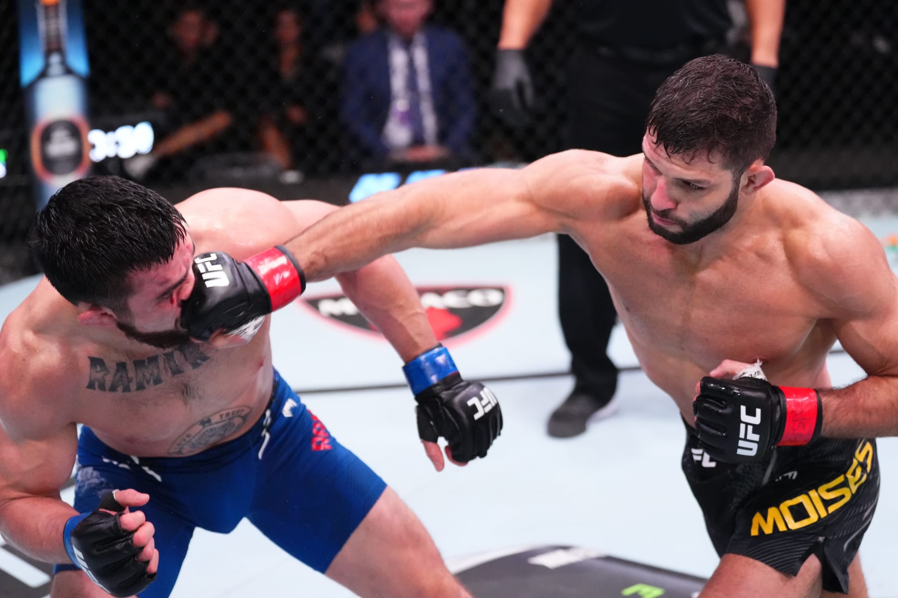 LAS VEGAS, NEVADA - MARCH 16: (R-L) Thiago Moises of Brazil punches Mitch Ramirez in their lightweight fight during the UFC Fight Night event at UFC APEX on March 16, 2024 in Las Vegas, Nevada. (Photo by Jeff Bottari/Zuffa LLC via Getty Images)