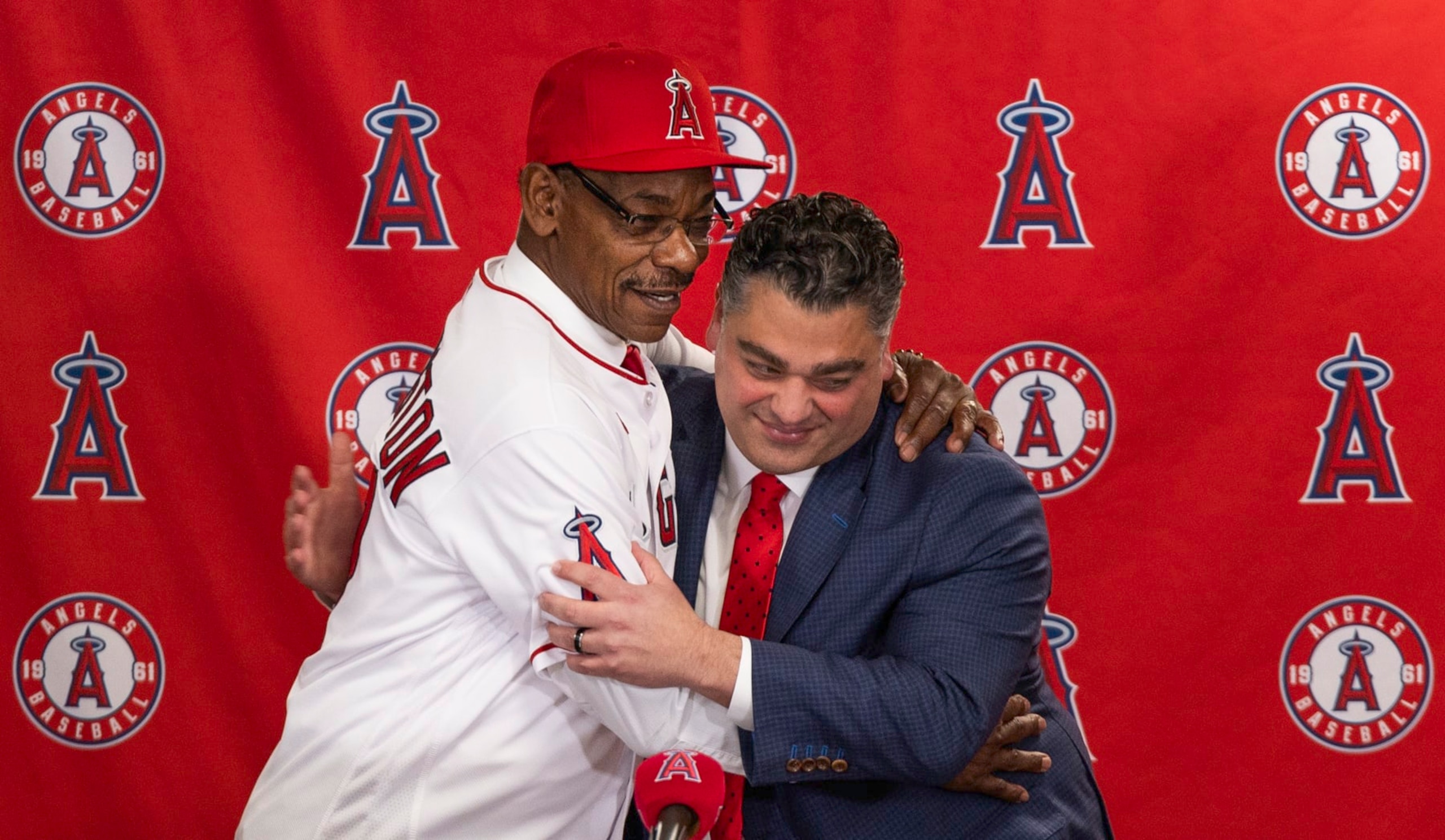 Anaheim, CA - November 15:  Angeles general manager Perry Minasian, right, hugs Angels new manager Ron Washington, left, as he shows off his new Angels jersey and hat during an introduction news conference at Angel Stadium in Anaheim Wednesday, Nov. 15, 2023.  (Allen J. Schaben / Los Angeles Times via Getty Images)