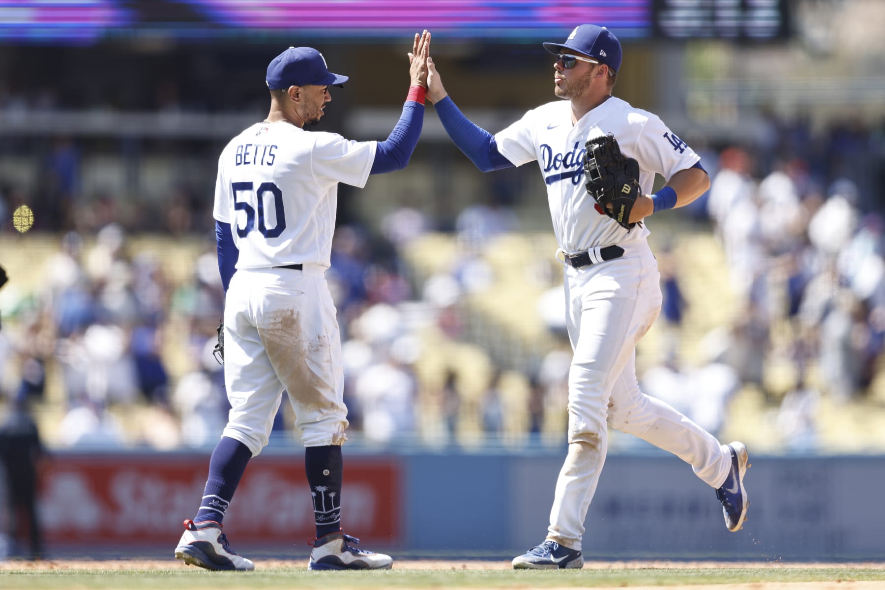 LOS ANGELES, CALIFORNIA - JULY 27: Mookie Betts #50 of the Los Angeles Dodgers celebrates with Gavin Lux #9 after defeating the Washington Nationals, 7-1, during the ninth inning at Dodger Stadium on July 27, 2022 in Los Angeles, California. (Photo by Michael Owens/Getty Images)