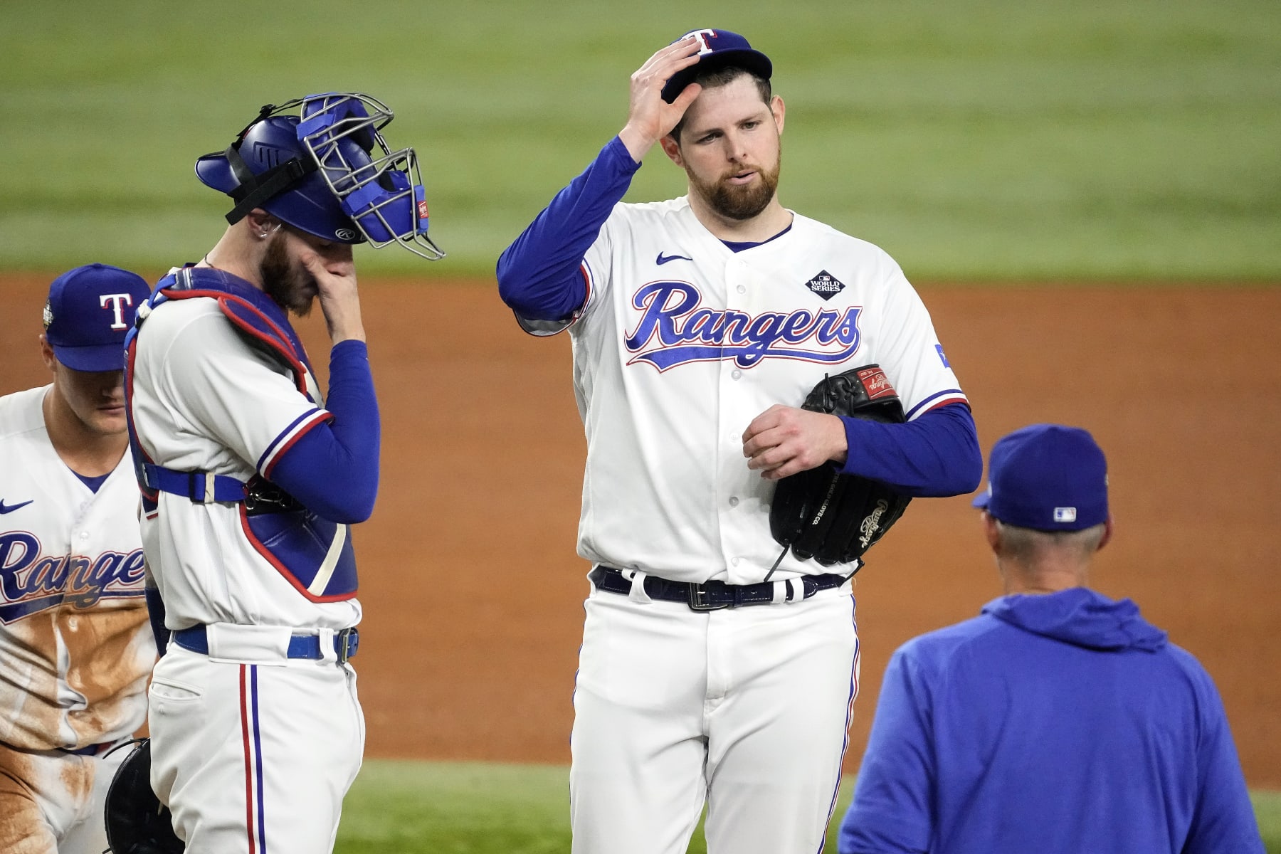 ARLINGTON, TEXAS - OCTOBER 28: Pitching coach Mike Maddux of the Texas Rangers meets with Jordan Montgomery #52 in the fourth inning against the Arizona Diamondbacks during Game Two of the World Series at Globe Life Field on October 28, 2023 in Arlington, Texas. (Photo by Sam Hodde/Getty Images)
