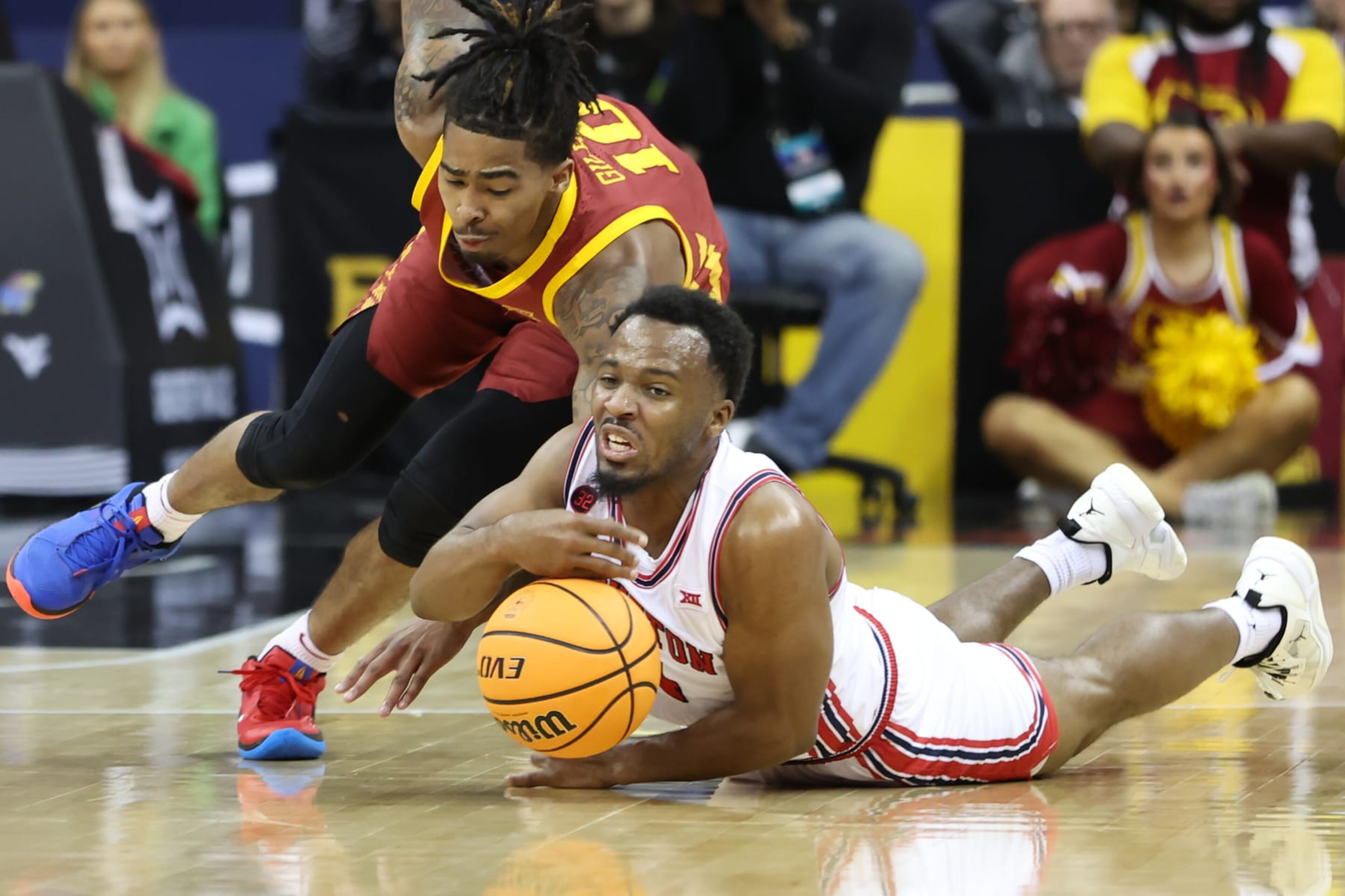 KANSAS CITY, MO - MARCH 16: Houston Cougars guard L.J. Cryer (4) and Iowa State Cyclones guard Keshon Gilbert (10) hit the floor for a loose ball in the first half of the Big 12 tournament final between the Iowa State Cyclones and Houston Cougars on Mar 16, 2024 at T-Mobile Center in Kansas City, MO. (Photo by Scott Winters/Icon Sportswire via Getty Images) KANSAS CITY, MO - MARCH 16: Houston Cougars guard L.J. Cryer (4) and Iowa State Cyclones guard Keshon Gilbert (10) hit the floor for a loose ball in the first half of the Big 12 tournament final between the Iowa State Cyclones and Houston Cougars on Mar 16, 2024 at T-Mobile Center in Kansas City, MO. (Photo by Scott Winters/Icon Sportswire via Getty Images)