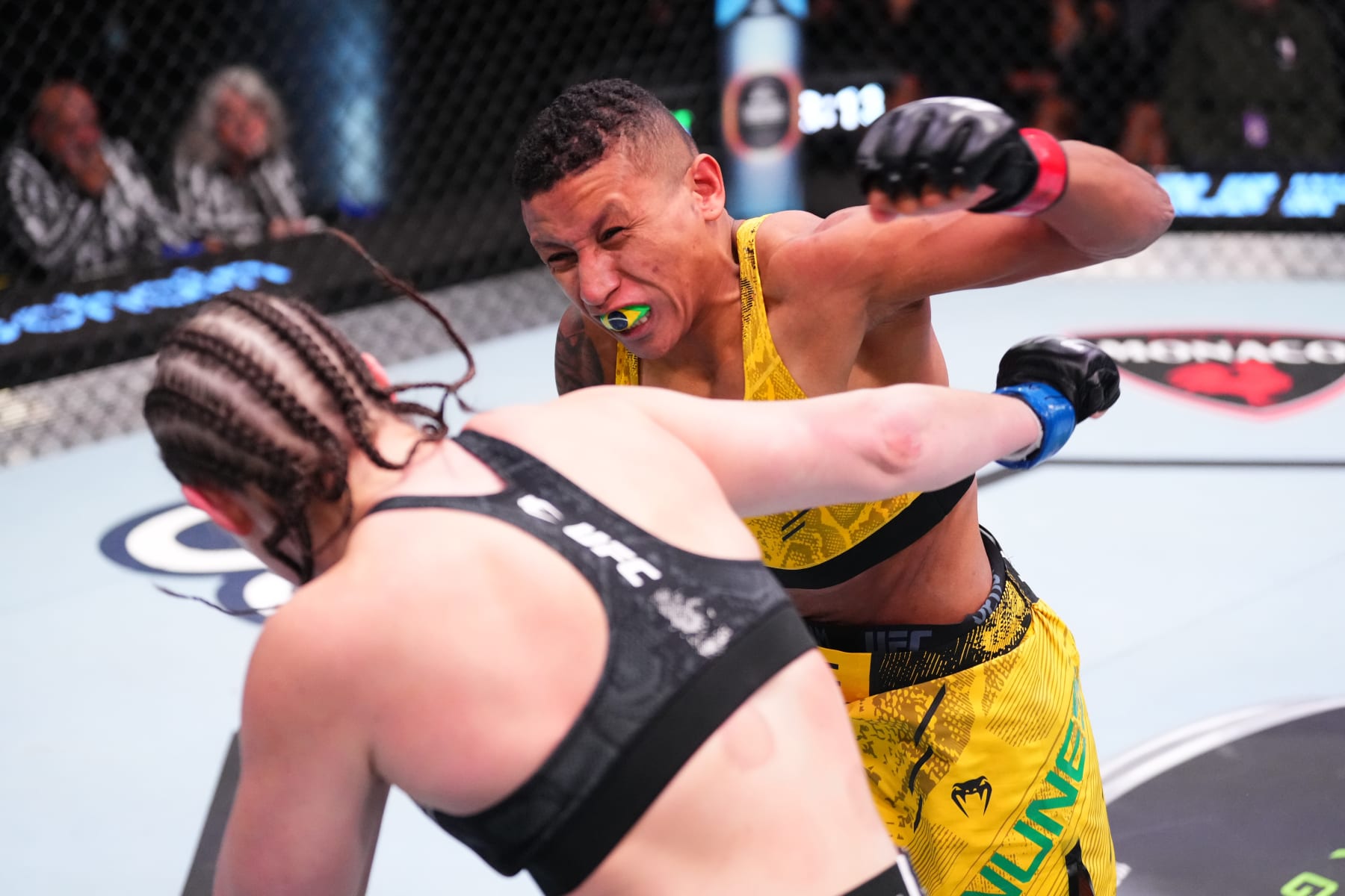 LAS VEGAS, NEVADA - MARCH 16: In this handout image provided by UFC, (R-L) Josiane Nunes of Brazil punches Chelsea Chandler in their women's bantamweight fight during the UFC Fight Night event at UFC APEX on March 16, 2024 in Las Vegas, Nevada. (Photo by Jeff Bottari/Zuffa LLC via Getty Images)