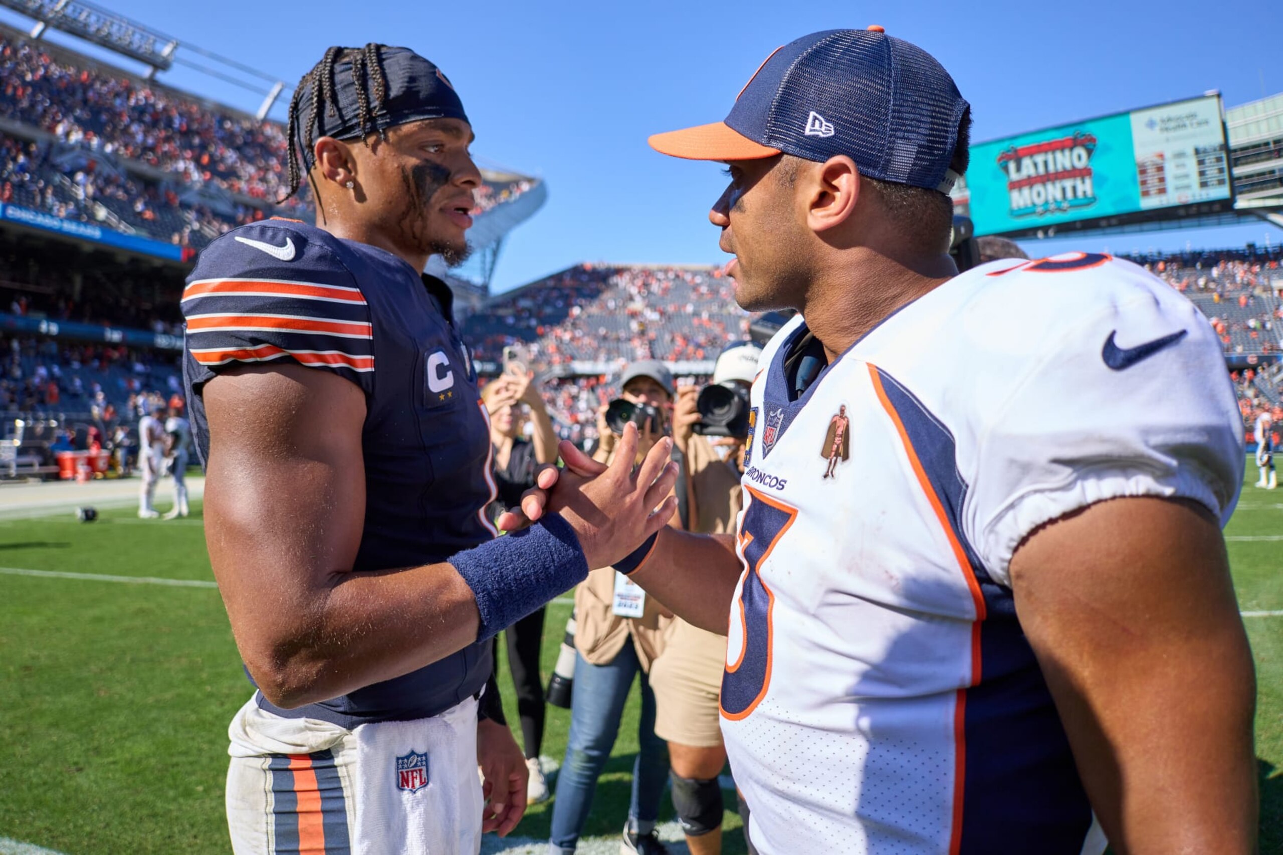 CHICAGO, IL - OCTOBER 01: Chicago Bears quarterback Justin Fields (1) and Denver Broncos quarterback Russell Wilson (3) shake hands after a game between the Chicago Bears and the Denver Broncos on October 01, 2023 at Soldier Field in Chicago, IL. (Photo by Robin Alam/Icon Sportswire via Getty Images)