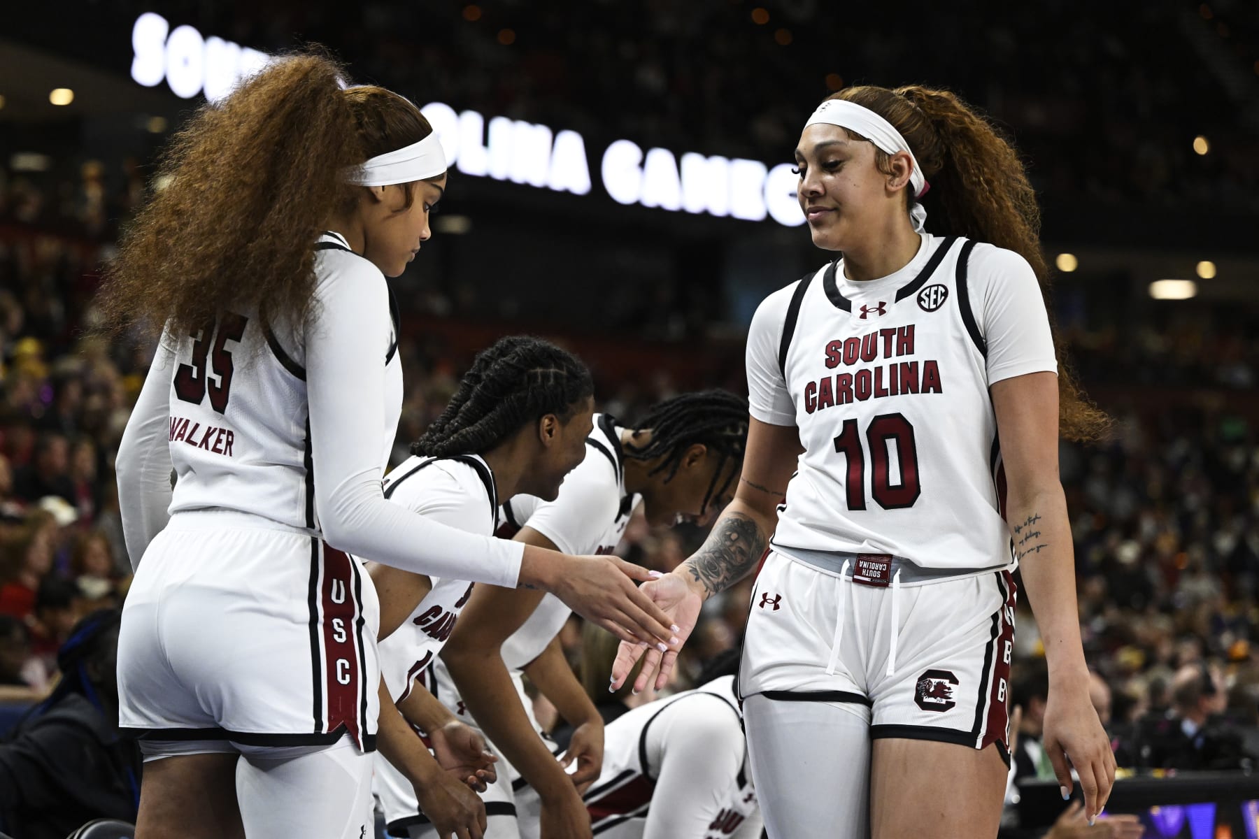 GREENVILLE, SOUTH CAROLINA - MARCH 10: Kamilla Cardoso #10 high fives Sakima Walker #35 of the South Carolina Gamecocks after being substituted off the court against the LSU Lady Tigers in the third quarter during the championship game of the SEC Women's Basketball Tournament at Bon Secours Wellness Arena on March 10, 2024 in Greenville, South Carolina. (Photo by Eakin Howard/Getty Images)