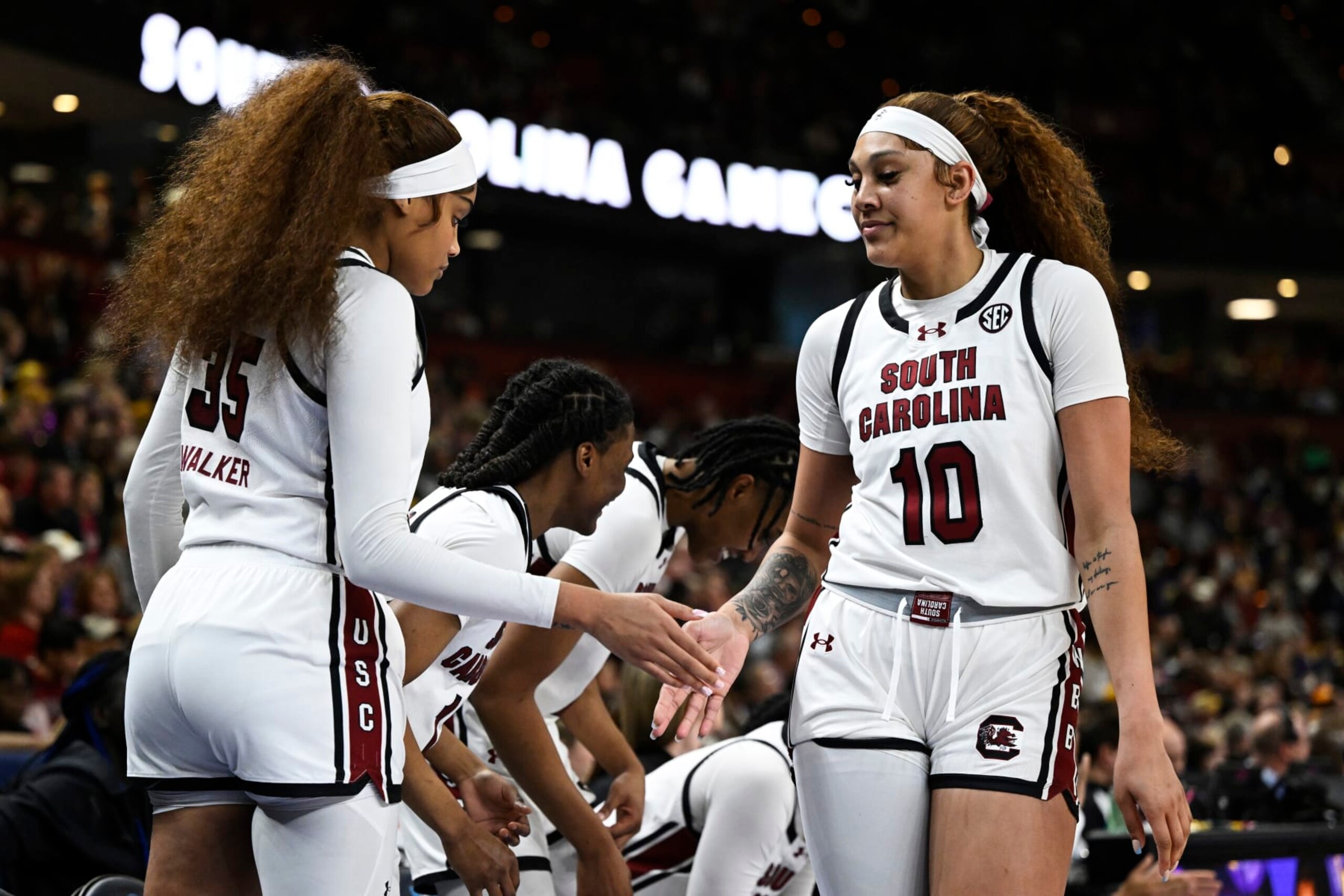 GREENVILLE, SOUTH CAROLINA - MARCH 10: Kamilla Cardoso #10 high fives Sakima Walker #35 of the South Carolina Gamecocks after being substituted off the court against the LSU Lady Tigers in the third quarter during the championship game of the SEC Women's Basketball Tournament at Bon Secours Wellness Arena on March 10, 2024 in Greenville, South Carolina. (Photo by Eakin Howard/Getty Images) GREENVILLE, SOUTH CAROLINA - MARCH 10: Kamilla Cardoso #10 high fives Sakima Walker #35 of the South Carolina Gamecocks after being substituted off the court against the LSU Lady Tigers in the third quarter during the championship game of the SEC Women's Basketball Tournament at Bon Secours Wellness Arena on March 10, 2024 in Greenville, South Carolina. (Photo by Eakin Howard/Getty Images)