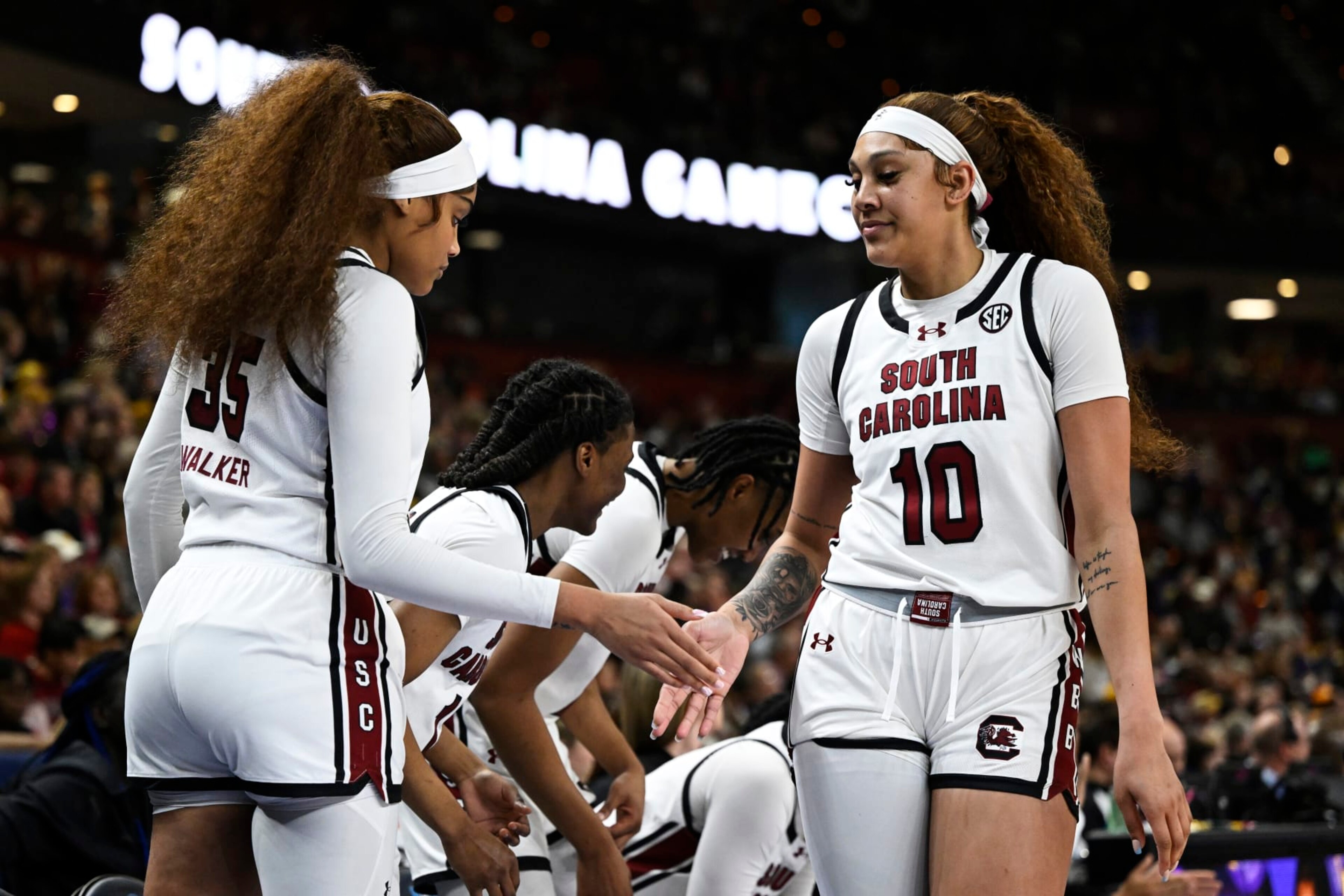 GREENVILLE, SOUTH CAROLINA - MARCH 10: Kamilla Cardoso #10 high fives Sakima Walker #35 of the South Carolina Gamecocks after being substituted off the court against the LSU Lady Tigers in the third quarter during the championship game of the SEC Women's Basketball Tournament at Bon Secours Wellness Arena on March 10, 2024 in Greenville, South Carolina. (Photo by Eakin Howard/Getty Images)
