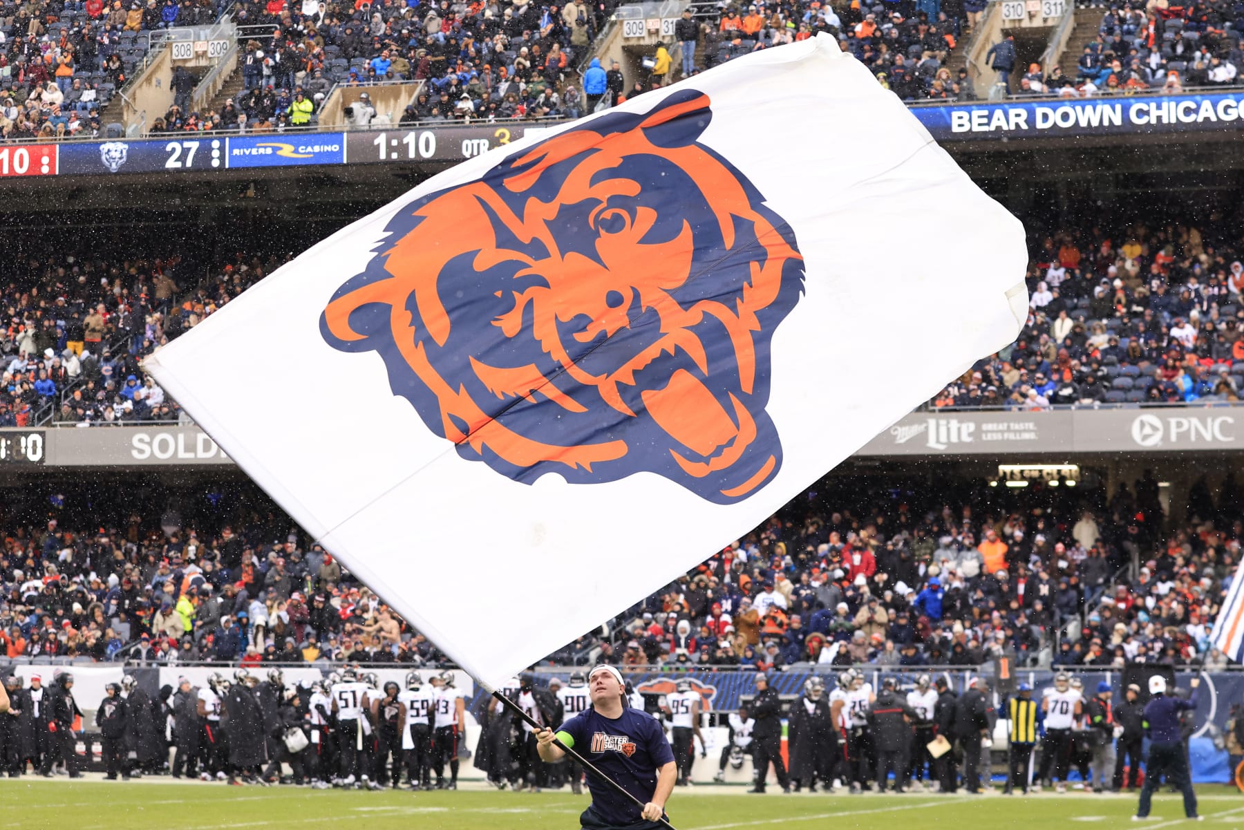 CHICAGO, ILLINOIS - DECEMBER 31: A Chicago Bears flag is flown on the field in the game against the Atlanta Falcons at Soldier Field on December 31, 2023 in Chicago, Illinois. (Photo by Justin Casterline/Getty Images)