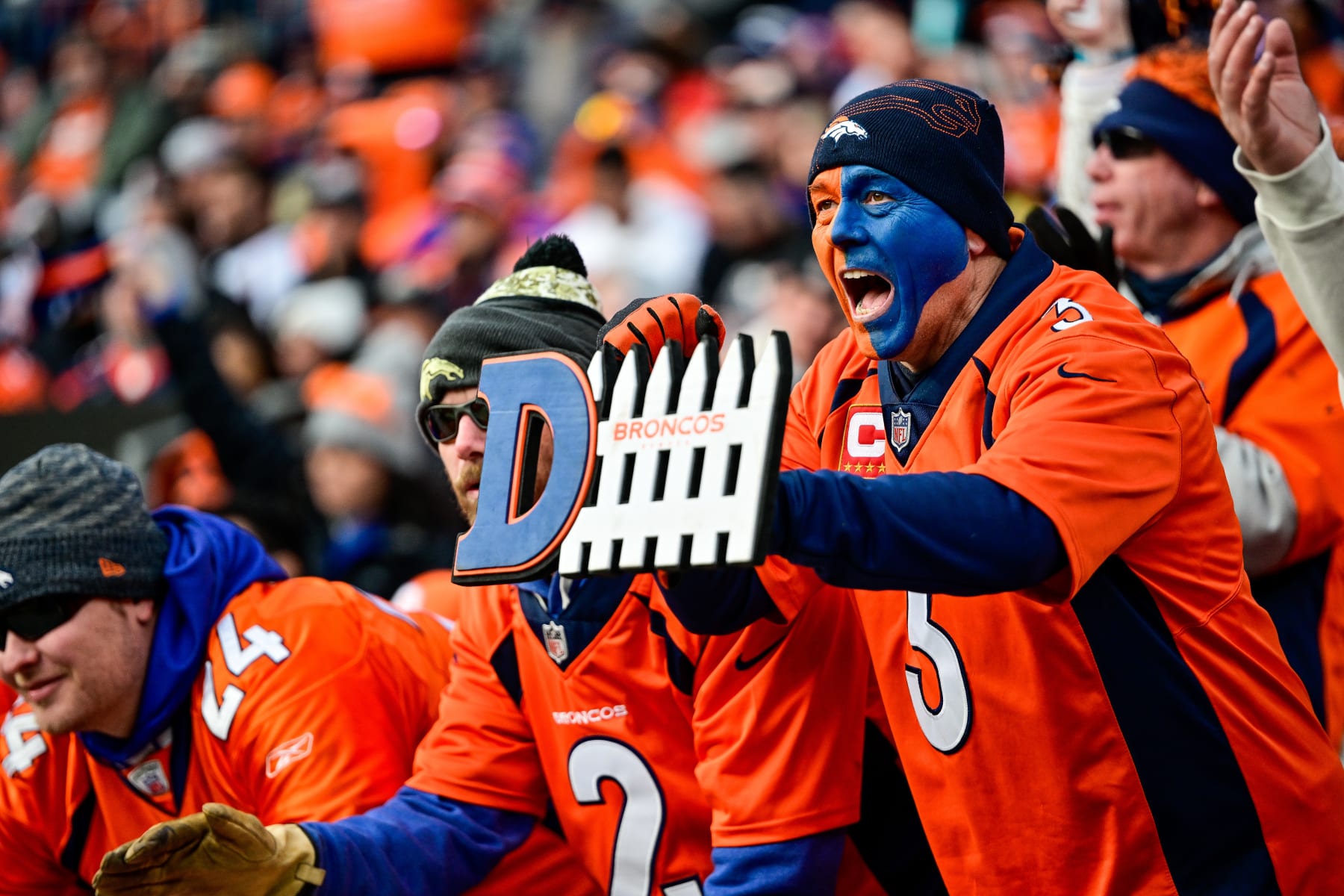 DENVER, COLORADO - DECEMBER 31:  A Denver Broncos fan with a painted face yells to support the defense in the first half of a game between the Denver Broncos and the Los Angeles Chargers at Empower Field at Mile High on December 31, 2023 in Denver, Colorado. (Photo by Dustin Bradford/Getty Images)
