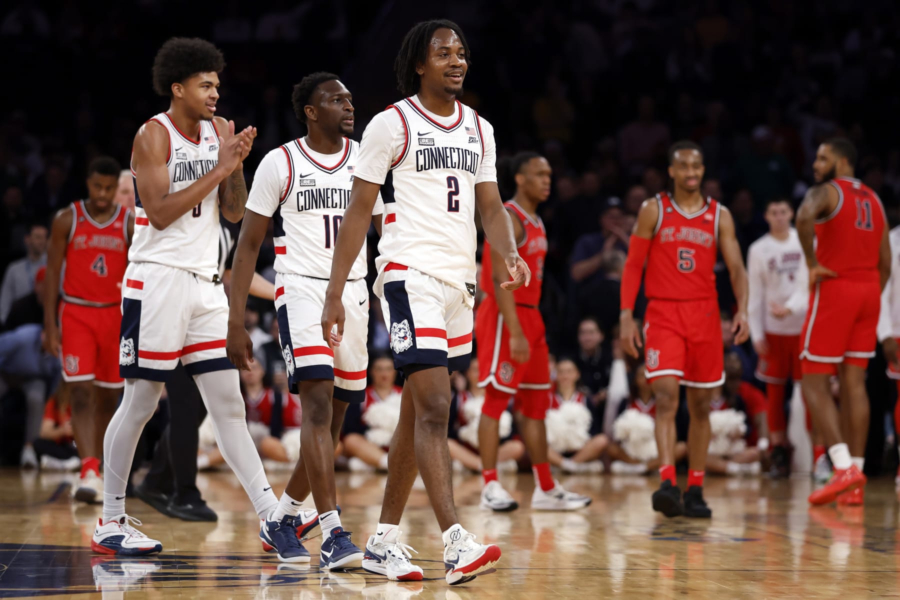NEW YORK, NEW YORK - MARCH 15: Tristen Newton #2, Hassan Diarra #10, and Jaylin Stewart #3 of the Connecticut Huskies react in the first half against the St. John's Red Storm during the Semifinal round of the Big East Basketball Tournament at Madison Square Garden on March 15, 2024 in New York City. (Photo by Sarah Stier/Getty Images)
