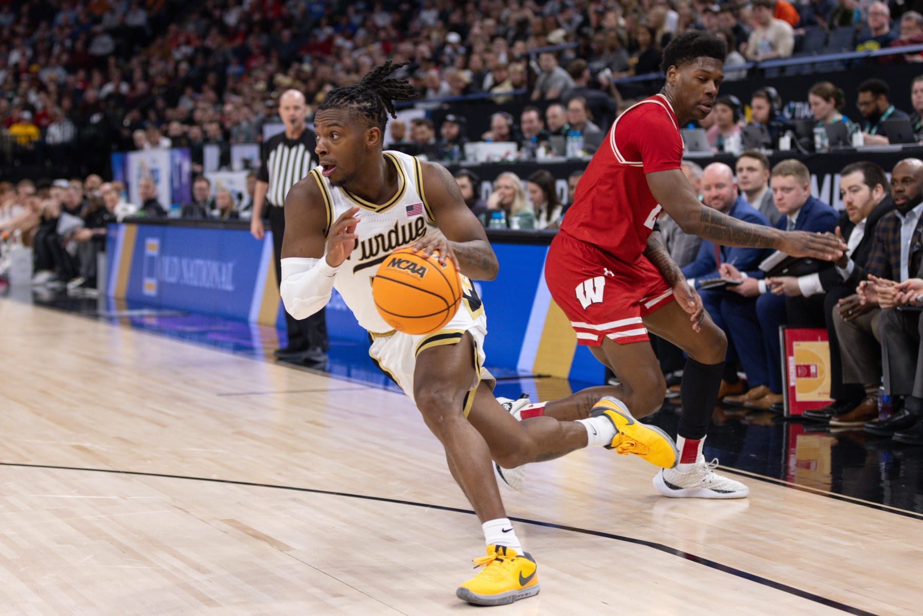 MINNEAPOLIS, MN - MARCH 16: Purdue Boilermakers guard Lance Jones (55) drives past Wisconsin Badgers guard AJ Storr (2) during the first half of a Big Ten Men's Basketball Tournament semi finals game between the Purdue Boilermakers and Wisconsin Badgers on March 16, 2024, at the the Target Center in Minneapolis, MN. (Photo by Bailey Hillesheim/Icon Sportswire via Getty Images)