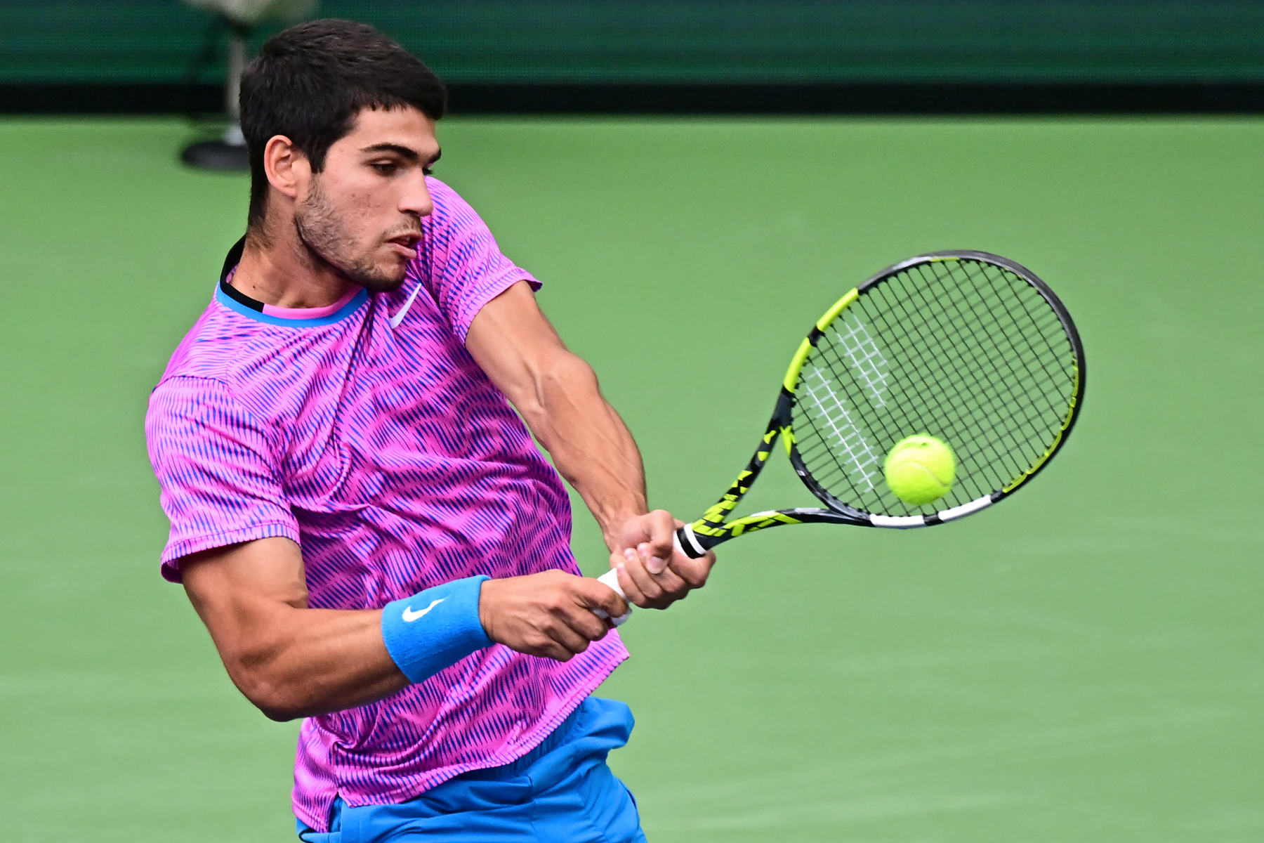 Spain's Carlos Alcaraz returns the ball to Russia's Daniil Medvedev during the ATP-WTA Indian Wells Masters men's final tennis match at the Indian Wells Tennis Garden in Indian Wells, California, on March 17, 2024. (Photo by Frederic J. BROWN / AFP) (Photo by FREDERIC J. BROWN/AFP via Getty Images)