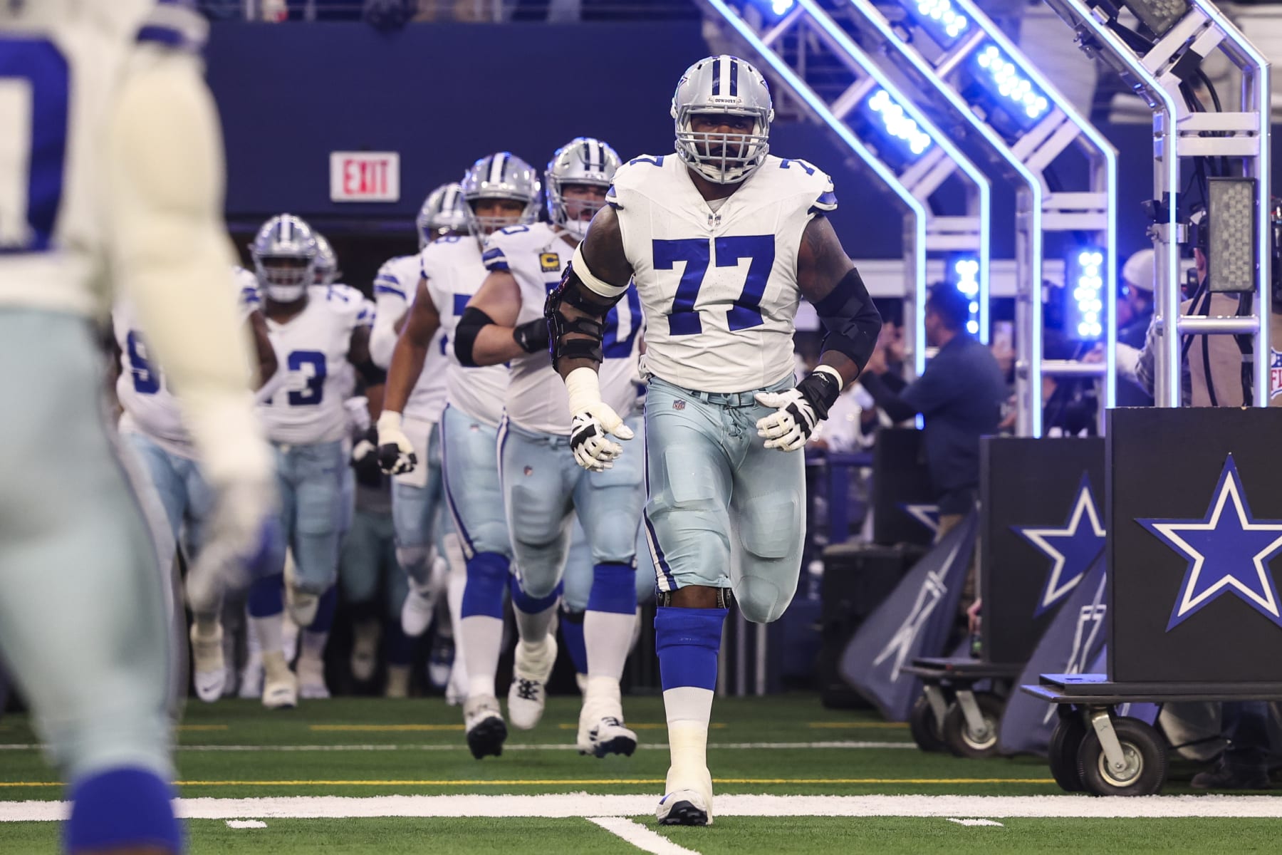 ARLINGTON, TX - JANUARY 14: Tyron Smith #77 of the Dallas Cowboys runs out of the tunnel prior to an NFL wild-card playoff football game against the Green Bay Packers at AT&T Stadium on January 14, 2024 in Arlington, Texas. (Photo by Perry Knotts/Getty Images)