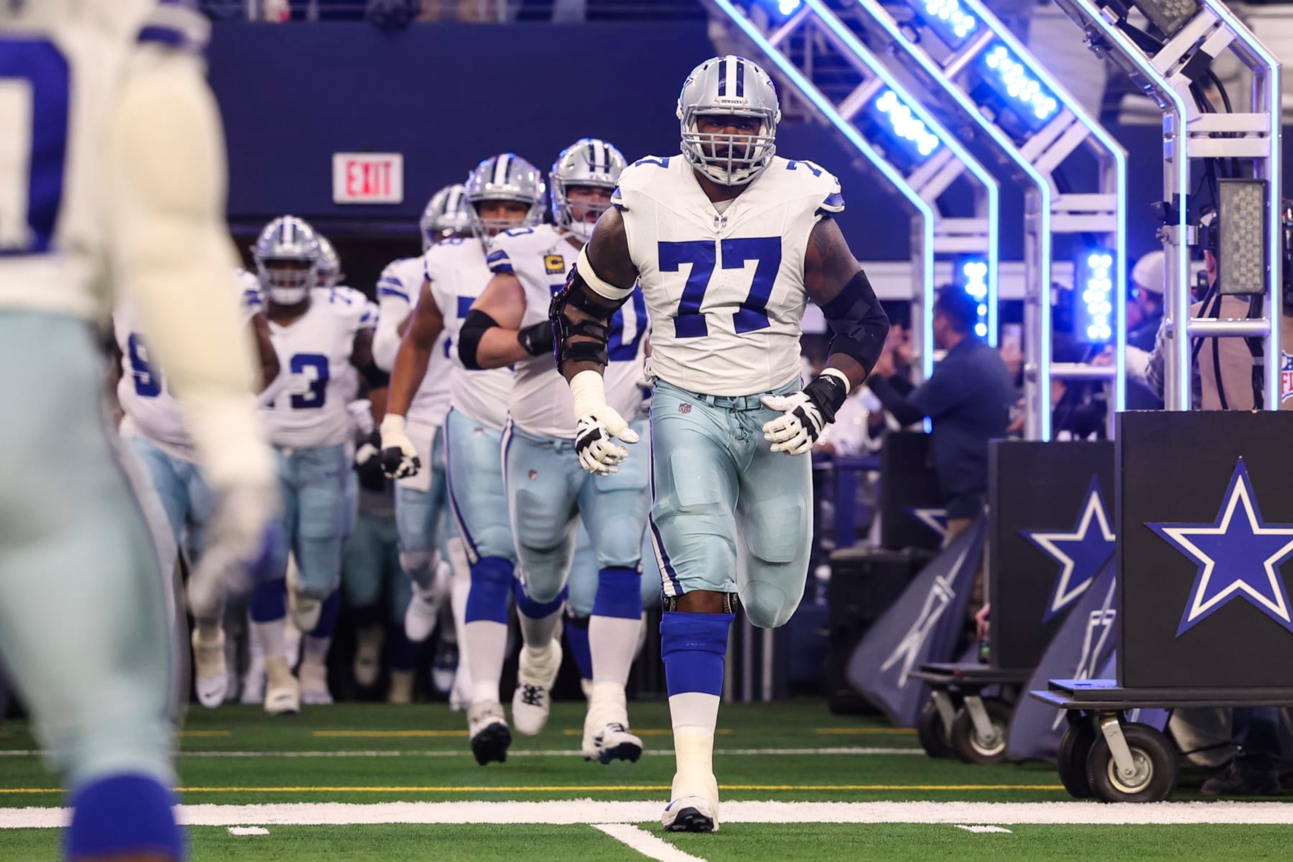ARLINGTON, TX - JANUARY 14: Tyron Smith #77 of the Dallas Cowboys runs out of the tunnel prior to an NFL wild-card playoff football game against the Green Bay Packers at AT&T Stadium on January 14, 2024 in Arlington, Texas. (Photo by Perry Knotts/Getty Images)