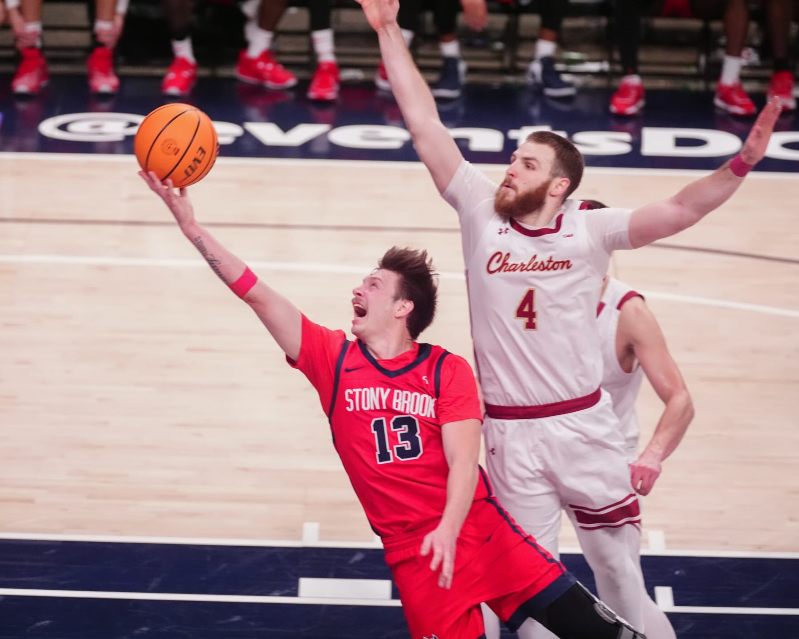 WASHINGTON, DC - MARCH 12: Stony Brook Seawolves Guard Dean Noll (13) shoots a layup against Charleston Cougars Guard Bryce Butler (4) during the second half of the CAA Men's Basketball Championship game between the Stony Brook Seawolves and the Charleston Cougars on March 12, 2024, at the Entertainment & Sports Arena in Washington DC. (Photo by Gregory Fisher/Icon Sportswire via Getty Images) WASHINGTON, DC - MARCH 12: Stony Brook Seawolves Guard Dean Noll (13) shoots a layup against Charleston Cougars Guard Bryce Butler (4) during the second half of the CAA Men's Basketball Championship game between the Stony Brook Seawolves and the Charleston Cougars on March 12, 2024, at the Entertainment & Sports Arena in Washington DC. (Photo by Gregory Fisher/Icon Sportswire via Getty Images)