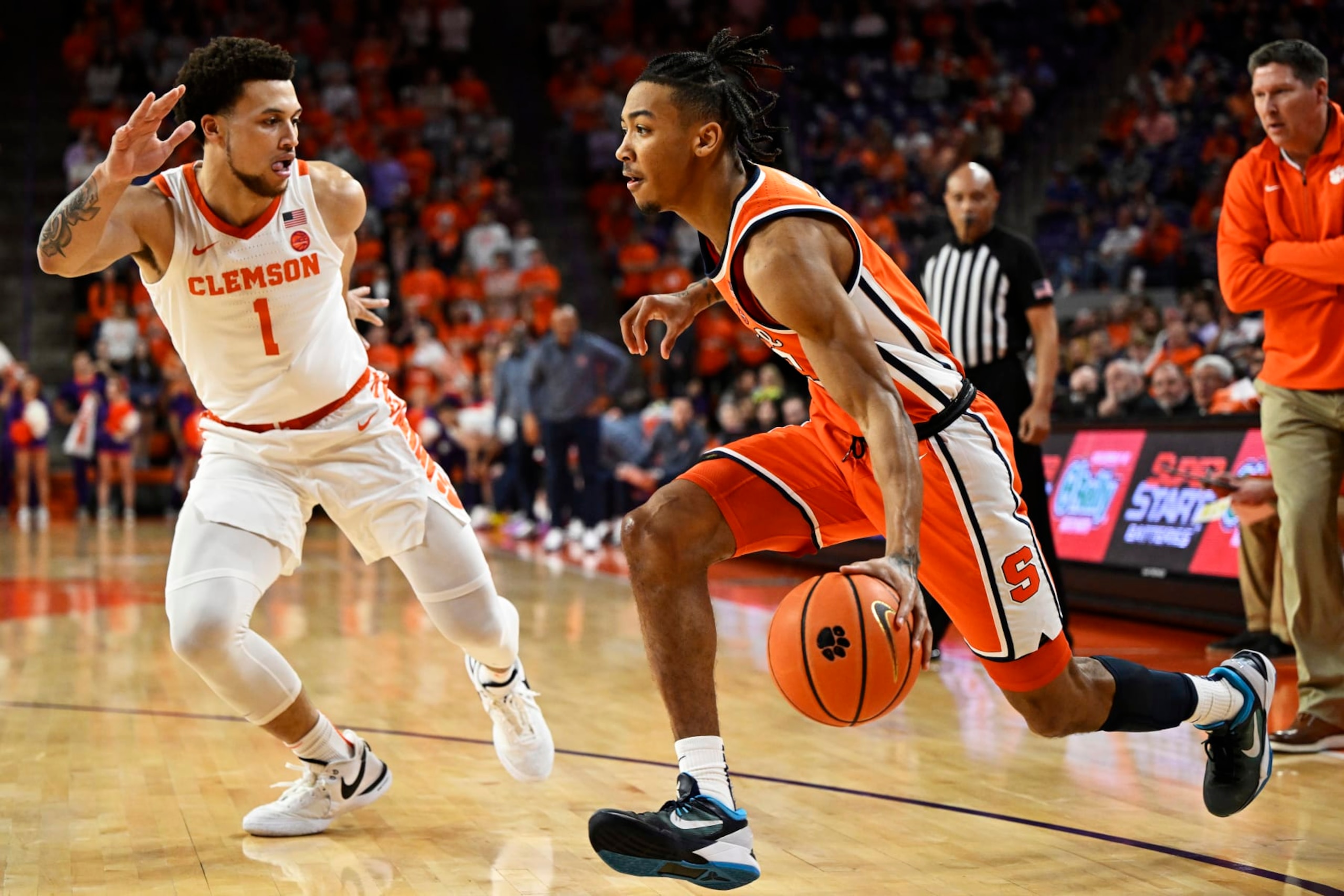CLEMSON, SOUTH CAROLINA - MARCH 05: Judah Mintz #3 of the Syracuse Orange drives to the basket against Chase Hunter #1 of the Clemson Tigers in the first half at Littlejohn Coliseum on March 05, 2024 in Clemson, South Carolina. (Photo by Eakin Howard/Getty Images) CLEMSON, SOUTH CAROLINA - MARCH 05: Judah Mintz #3 of the Syracuse Orange drives to the basket against Chase Hunter #1 of the Clemson Tigers in the first half at Littlejohn Coliseum on March 05, 2024 in Clemson, South Carolina. (Photo by Eakin Howard/Getty Images)