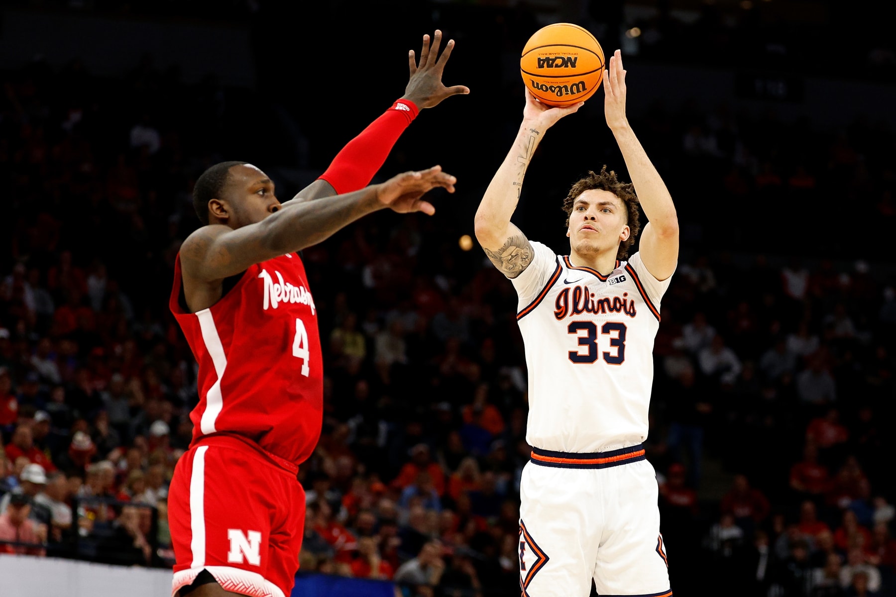 MINNEAPOLIS, MINNESOTA - MARCH 16: Coleman Hawkins #33 of the Illinois Fighting Illini shoots the ball against Juwan Gary #4 of the Nebraska Cornhuskers in the first half at Target Center in the Semifinals of the Big Ten Tournament on March 16, 2024 in Minneapolis, Minnesota. (Photo by David Berding/Getty Images)