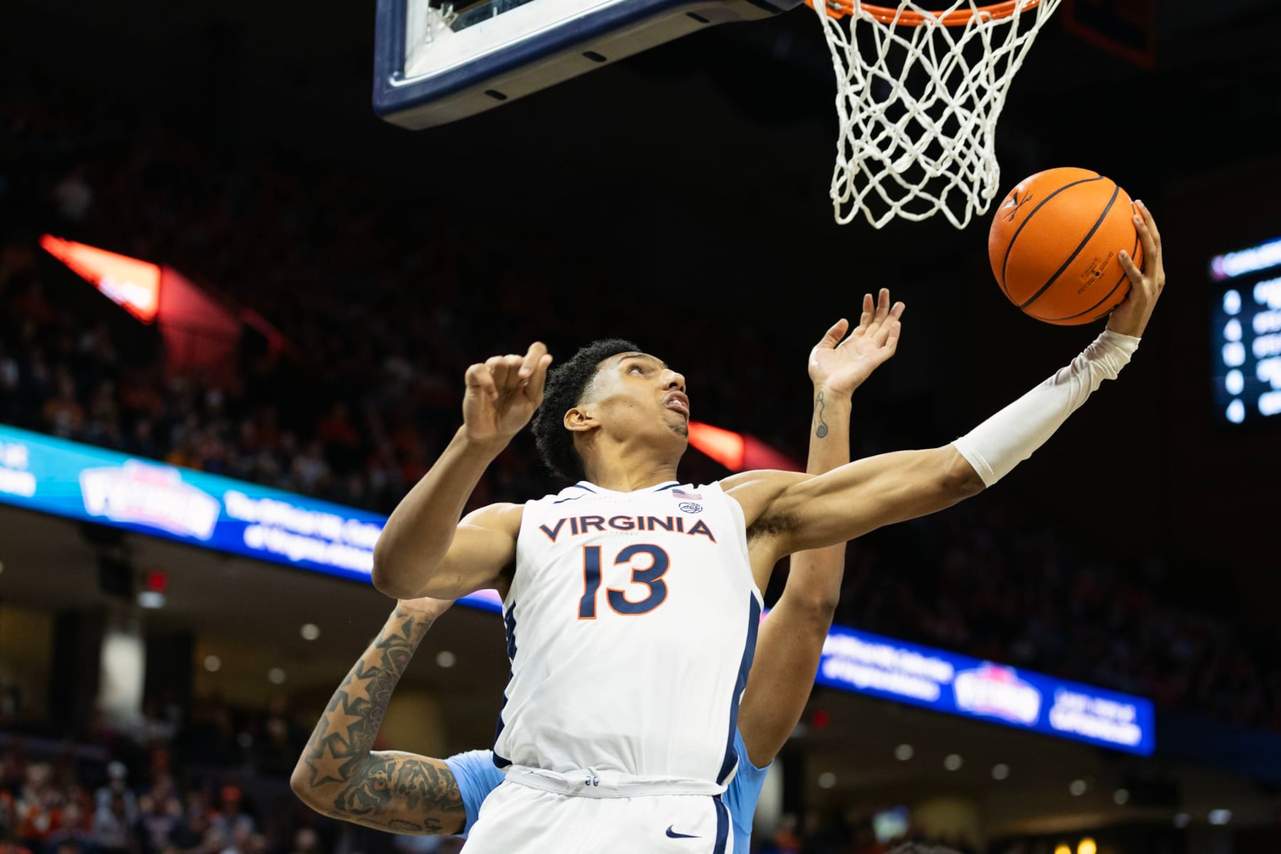 CHARLOTTESVILLE, VIRGINIA - FEBRUARY 24: Ryan Dunn #13 of the Virginia Cavaliers shoots past Armando Bacot #5 of the North Carolina Tar Heels in the second half during a game at John Paul Jones Arena on February 24, 2024 in Charlottesville, Virginia. (Photo by Ryan M. Kelly/Getty Images) CHARLOTTESVILLE, VIRGINIA - FEBRUARY 24: Ryan Dunn #13 of the Virginia Cavaliers shoots past Armando Bacot #5 of the North Carolina Tar Heels in the second half during a game at John Paul Jones Arena on February 24, 2024 in Charlottesville, Virginia. (Photo by Ryan M. Kelly/Getty Images)