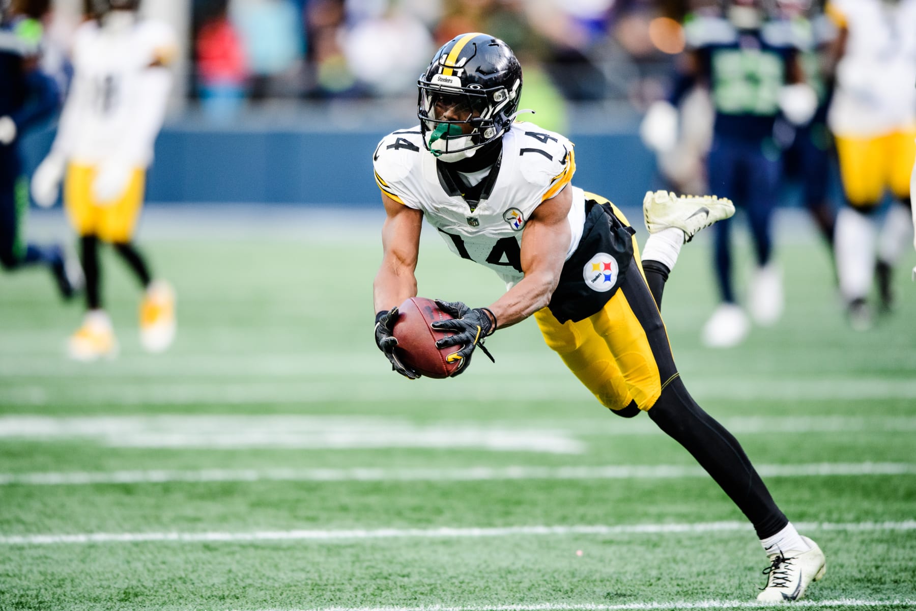 SEATTLE, WASHINGTON - DECEMBER 31: George Pickens #14 of the Pittsburgh Steelers catches the ball during the fourth quarter of the game against the Seattle Seahawks at Lumen Field on December 31, 2023 in Seattle, Washington. (Photo by Jane Gershovich/Getty Images)