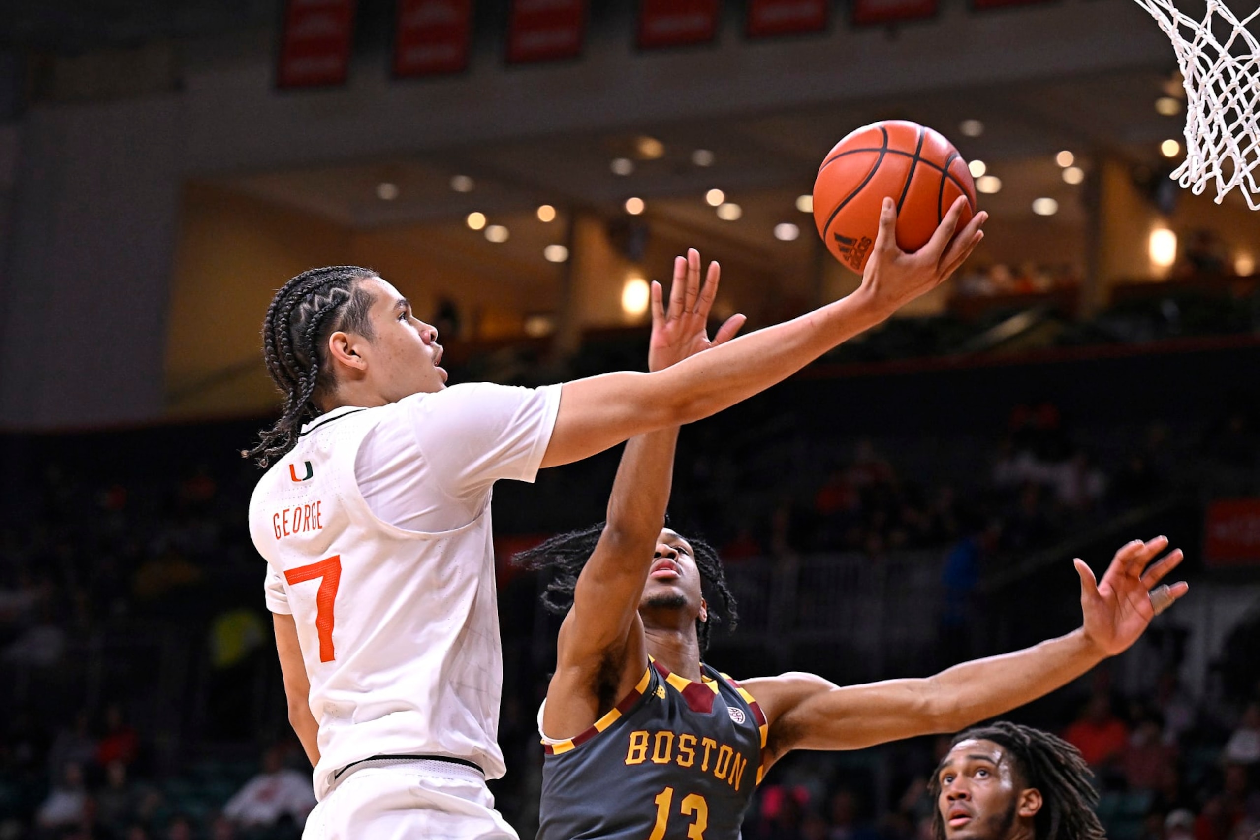 CORAL GABLES, FL - MARCH 06: Miami guard Kyshawn George (7) puts up a basket while defended by Boston College guard Donald Hand Jr. (13) in the first half as the Miami Hurricanes faced the Boston College Eagles on March 6, 2024, at the Watsco Center in Coral Gables, Florida. (Photo by Samuel Lewis/Icon Sportswire via Getty Images) CORAL GABLES, FL - MARCH 06: Miami guard Kyshawn George (7) puts up a basket while defended by Boston College guard Donald Hand Jr. (13) in the first half as the Miami Hurricanes faced the Boston College Eagles on March 6, 2024, at the Watsco Center in Coral Gables, Florida. (Photo by Samuel Lewis/Icon Sportswire via Getty Images)