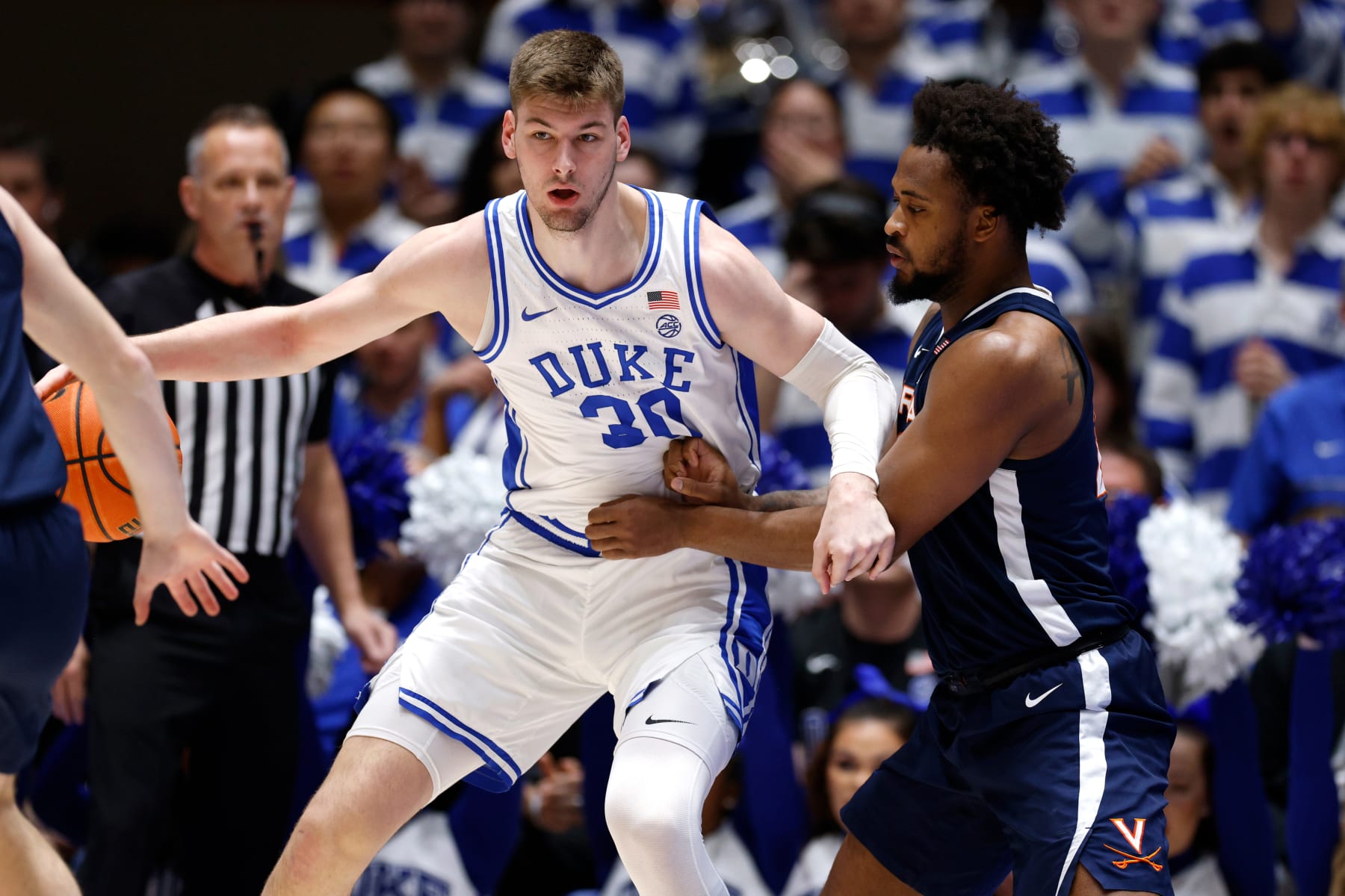 DURHAM, NORTH CAROLINA - MARCH 2: Kyle Filipowski #30 of the Duke Blue Devils moves the ball against Jordan Minor #22 of the Virginia Cavaliers during the first half of the game at Cameron Indoor Stadium on March 2, 2024 in Durham, North Carolina. (Photo by Lance King/Getty Images)