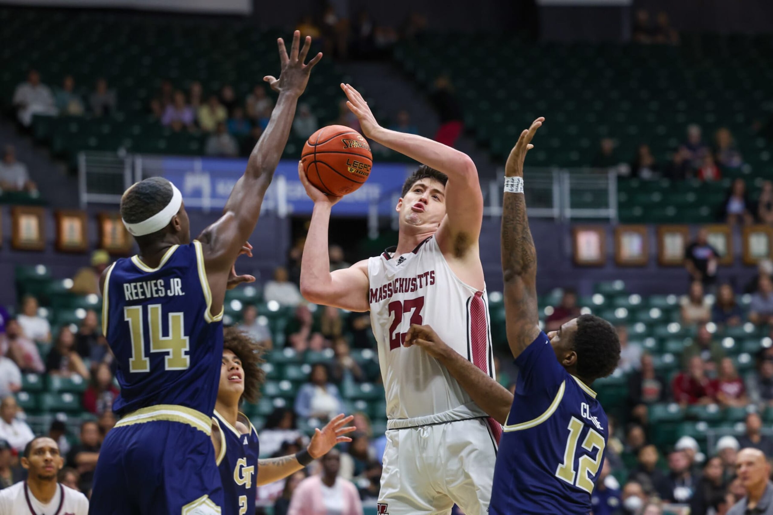 HONOLULU, HAWAII - DECEMBER 21: Josh Cohen #23 of the Massachusetts Minutemen looks to pass as he is double teamed by Kowacie Reeves, Jr. #14 and Tyzhaun Claude #12 of the Georgia Tech Yellow Jackets during the second half of their game in the Diamond Head Classic at SimpliFi Arena on December 21, 2023 in Honolulu, Hawaii. (Photo by Darryl Oumi/Getty Images) HONOLULU, HAWAII - DECEMBER 21: Josh Cohen #23 of the Massachusetts Minutemen looks to pass as he is double teamed by Kowacie Reeves, Jr. #14 and Tyzhaun Claude #12 of the Georgia Tech Yellow Jackets during the second half of their game in the Diamond Head Classic at SimpliFi Arena on December 21, 2023 in Honolulu, Hawaii. (Photo by Darryl Oumi/Getty Images)